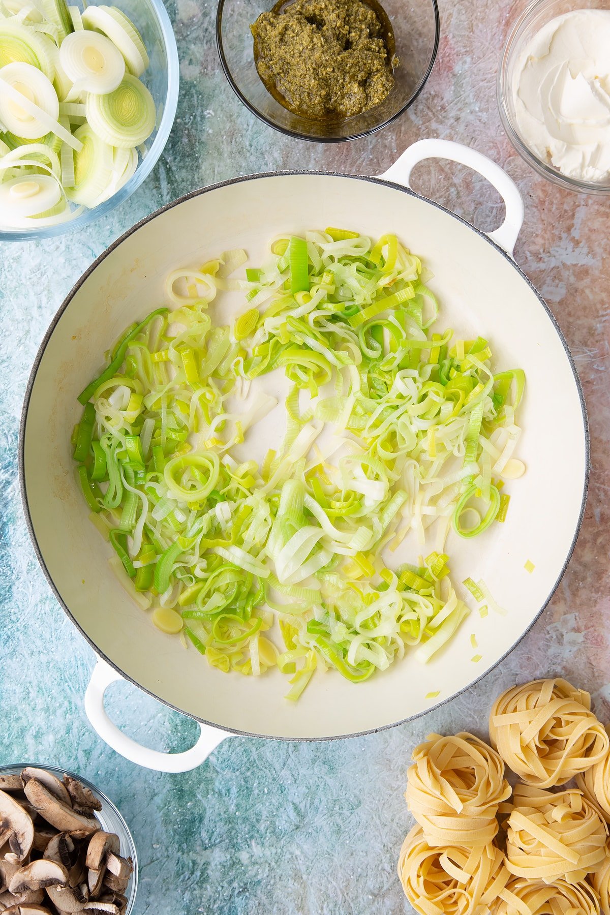 Overhead shot of the sliced leeks having been softened on a low heat in the pan.