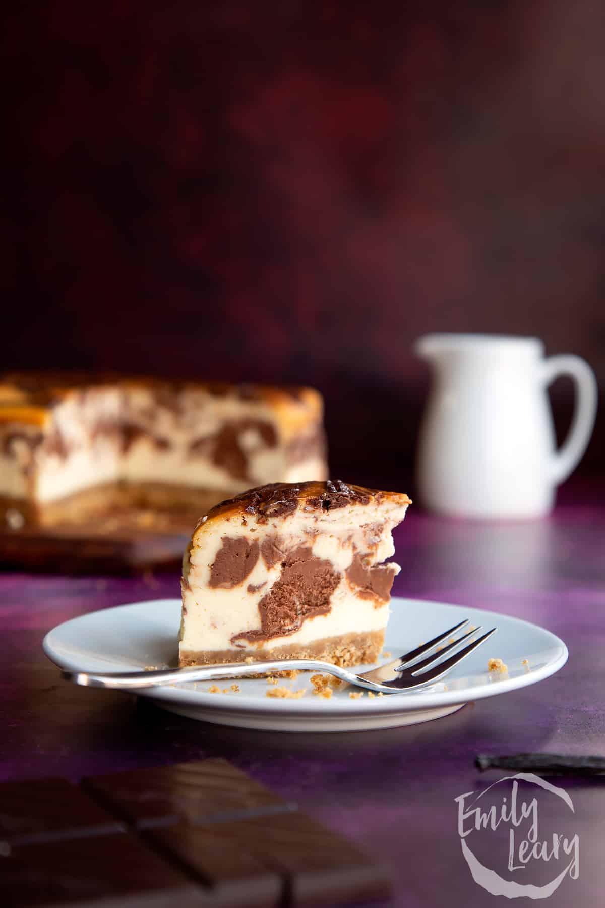 Slice of marble cheesecake on a white plate.