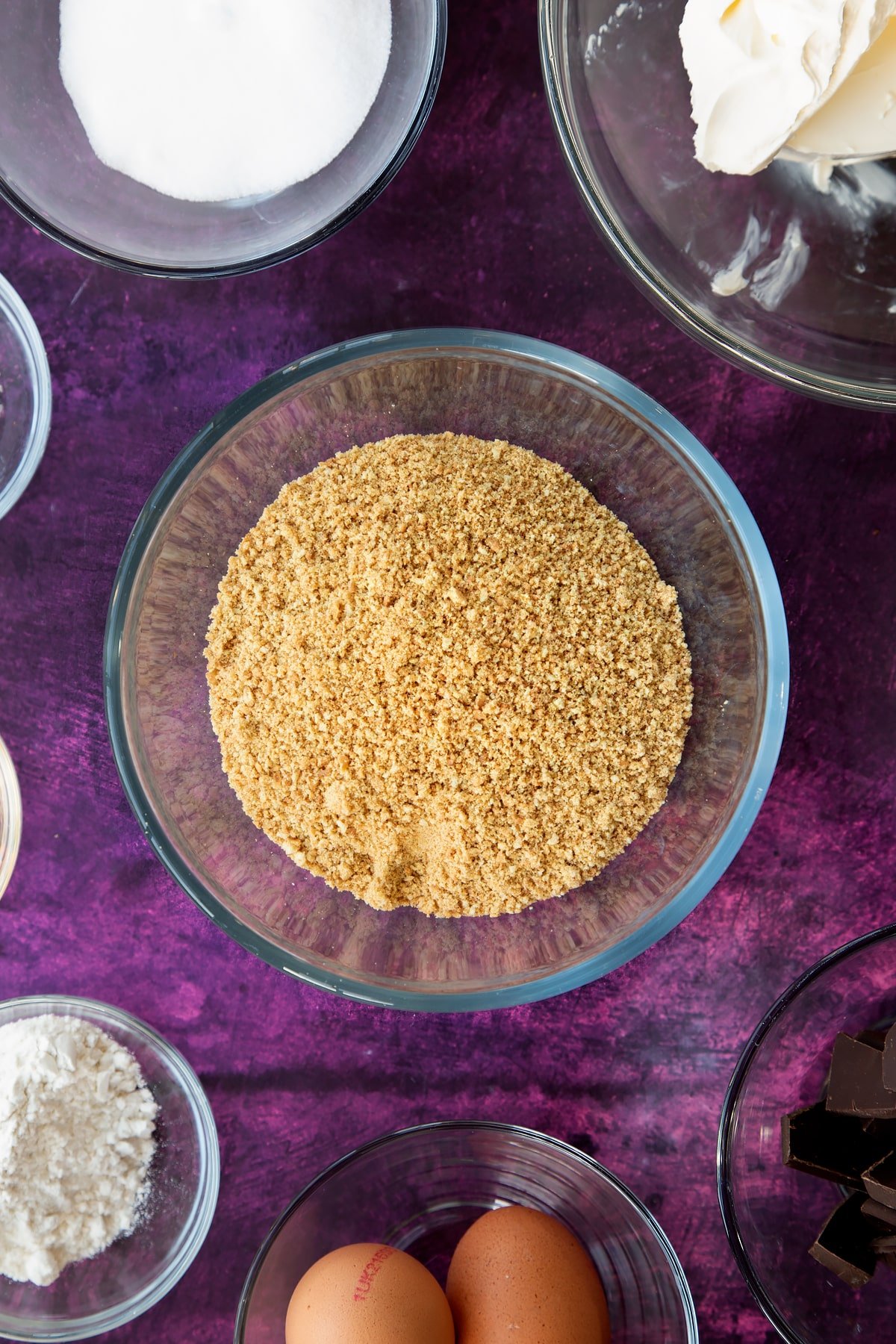 Overhead shot of crumbled biscuits in a mixing bowl.