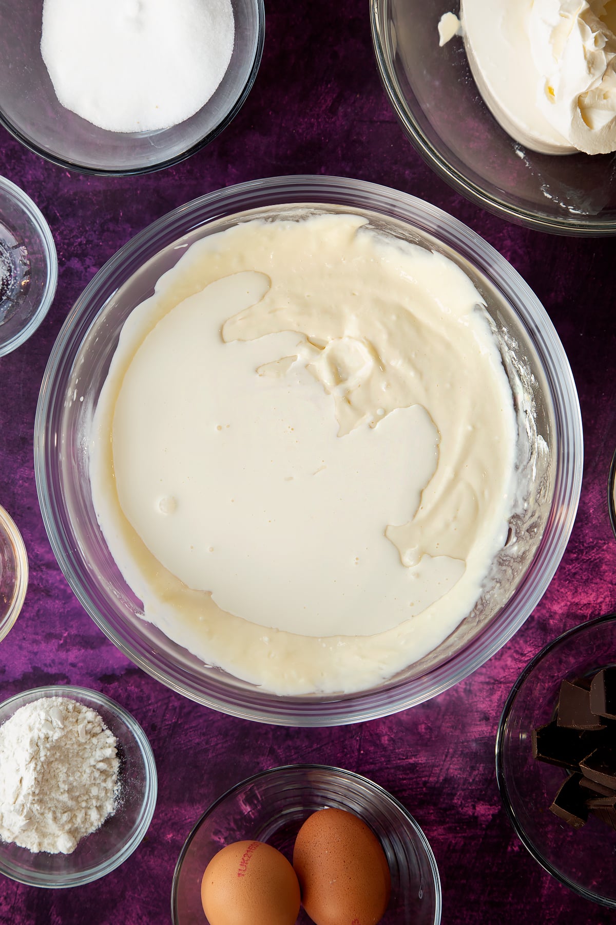 Adding cream to the marble cheesecake mixture.