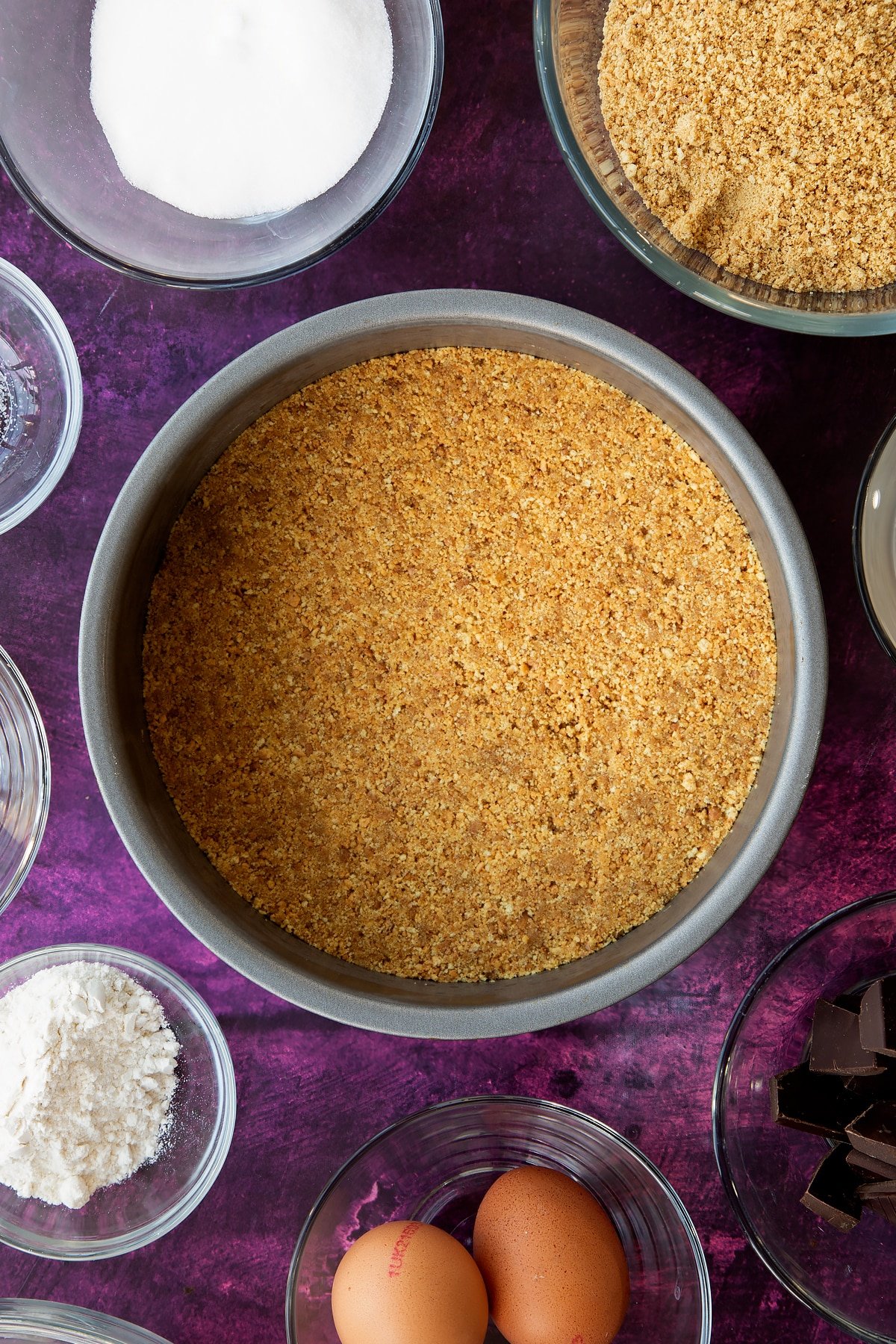 Forming the base of the marble cheesecake in the non-stick cake tin.