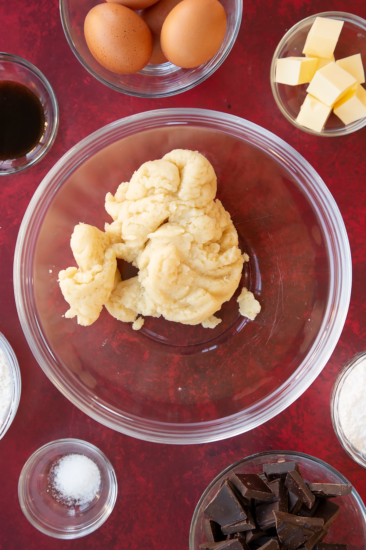 Mini eclairs pastry in a clear glass bowl.