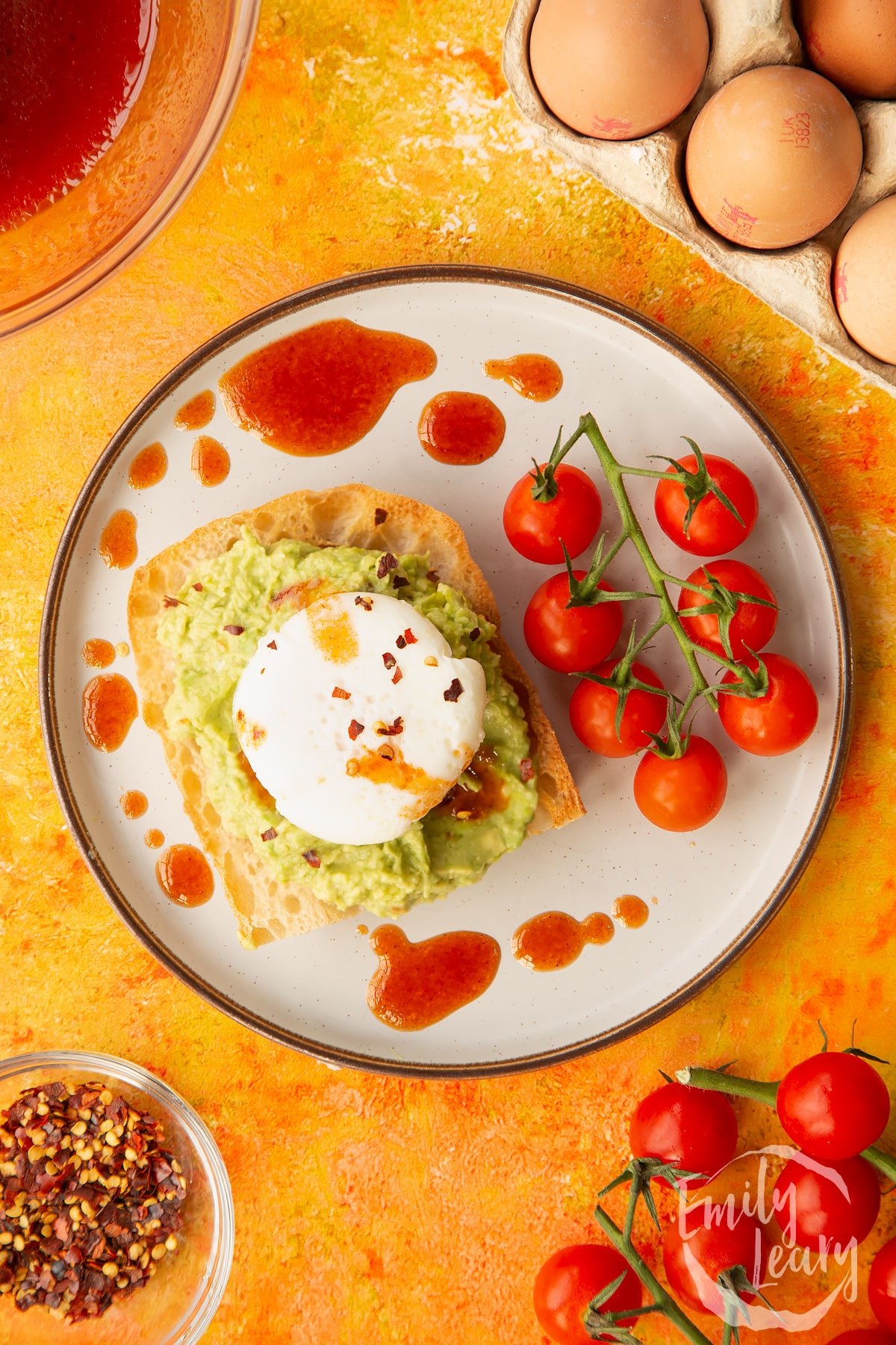 Overhead shot of avocado on toast with a poached egg ontop.