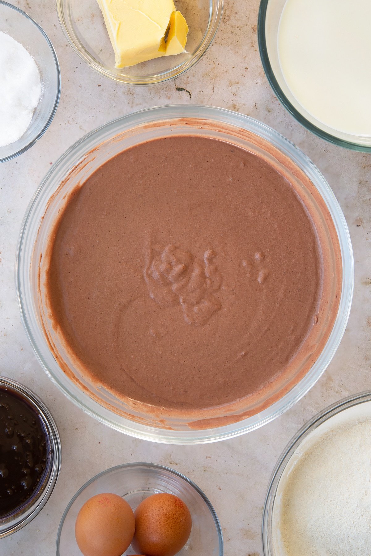 Overhead shot of the mixing bowl after the red velvet waffle ingredients have been whisked together.