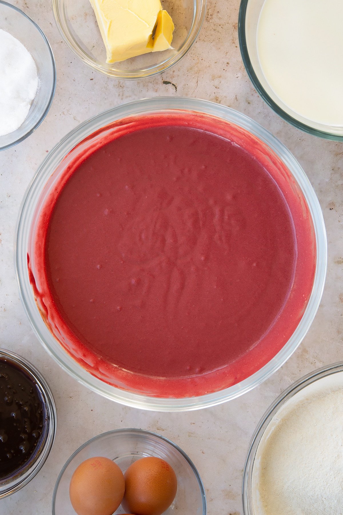 Overhead shot of the red velvet waffles ingredients mixed together in a mixing bowl.