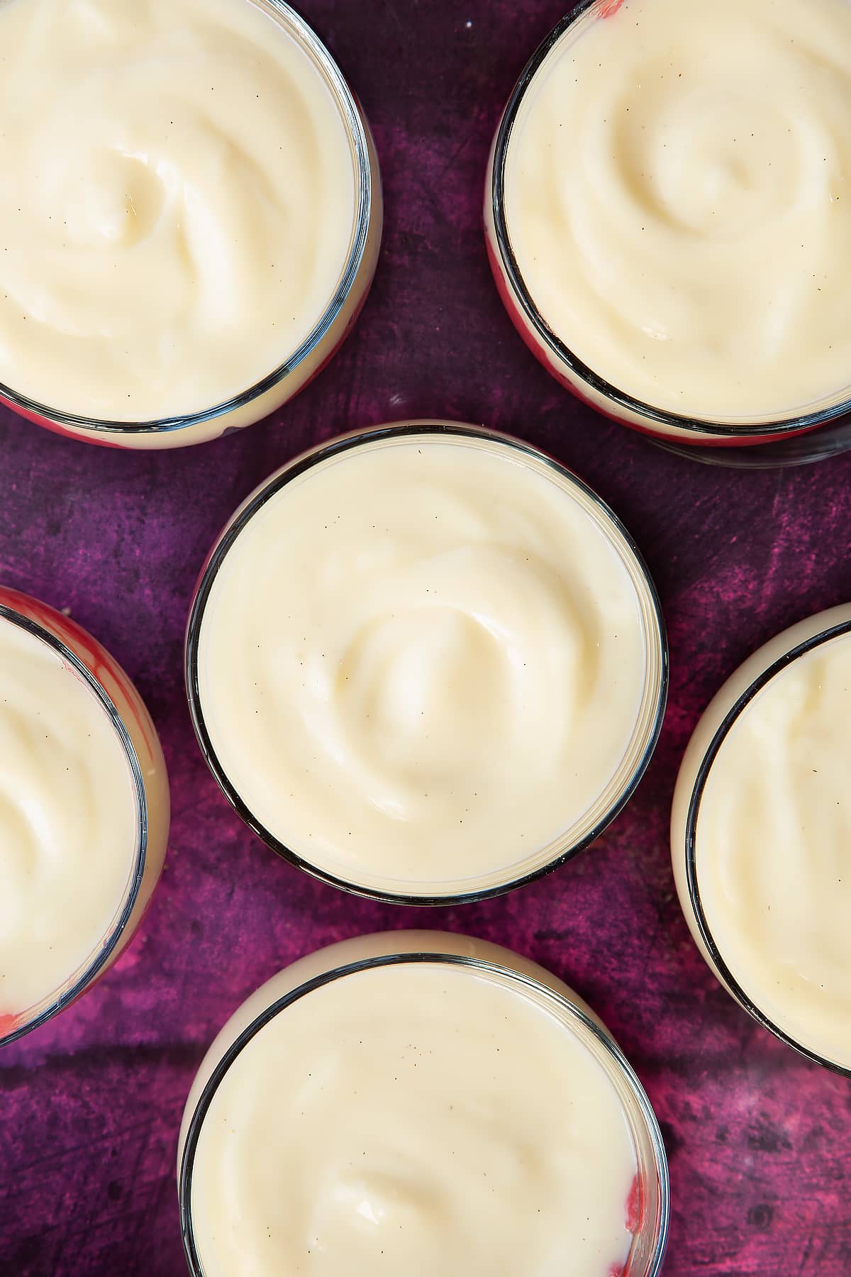 6 clear serving dishes topped with custard mixture.