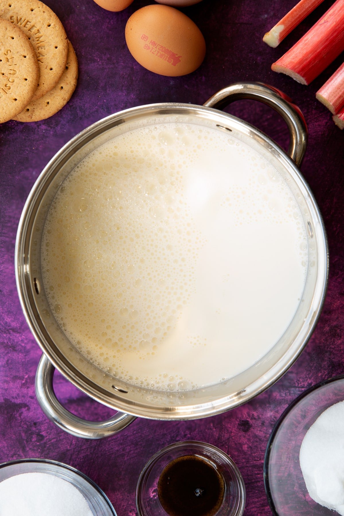 custard mix bubbling and frothing in a saucepan.