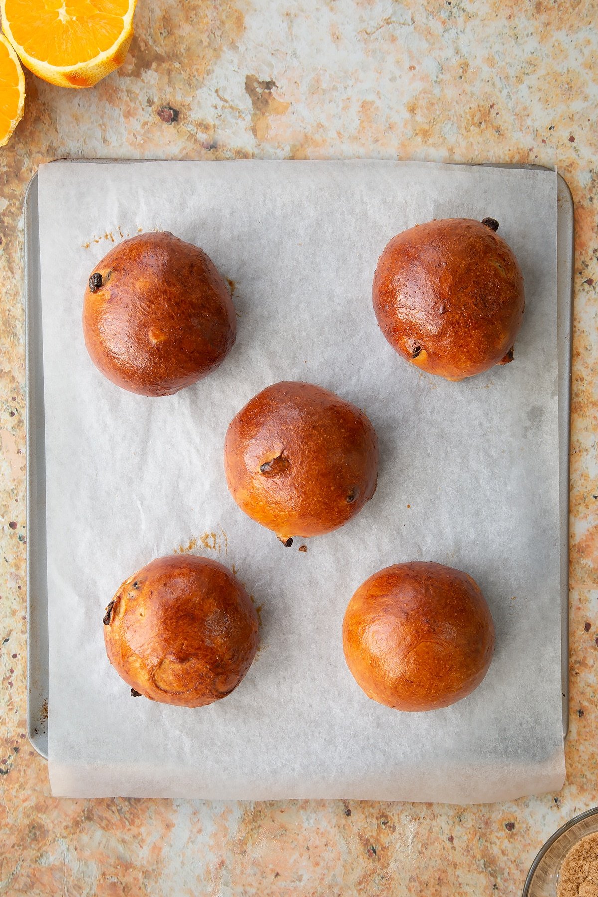 Overhead shot of the spiced fruit buns having been in the oven.