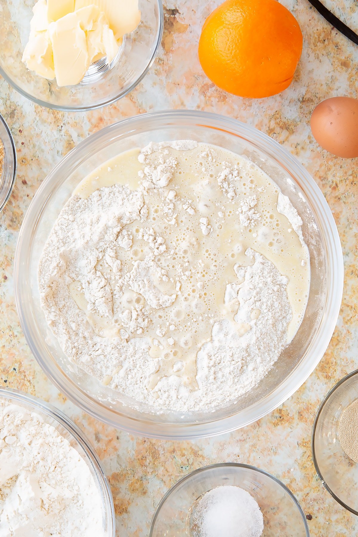 Mixing the wet and dry ingredients together for the dough together in a mixing bowl.