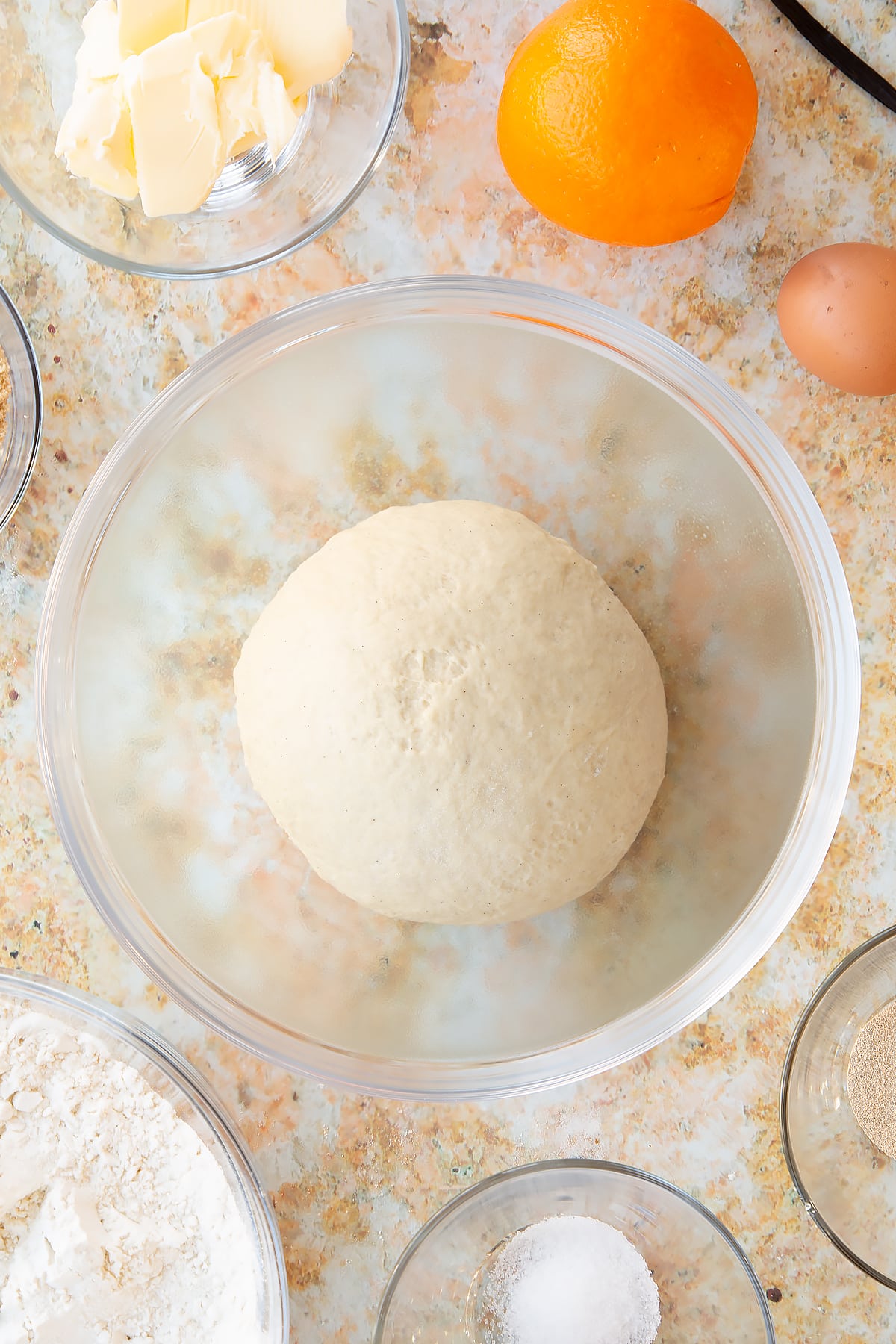Overhead shot of the dough in the form of a ball used for the spiced fruit buns.