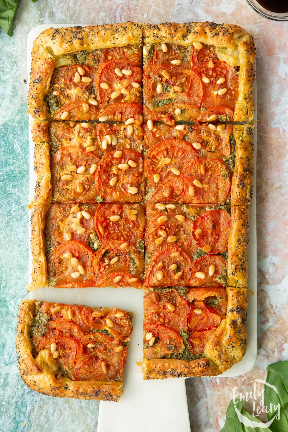 Finished vegan puff pastry tart served on a decorative white board.