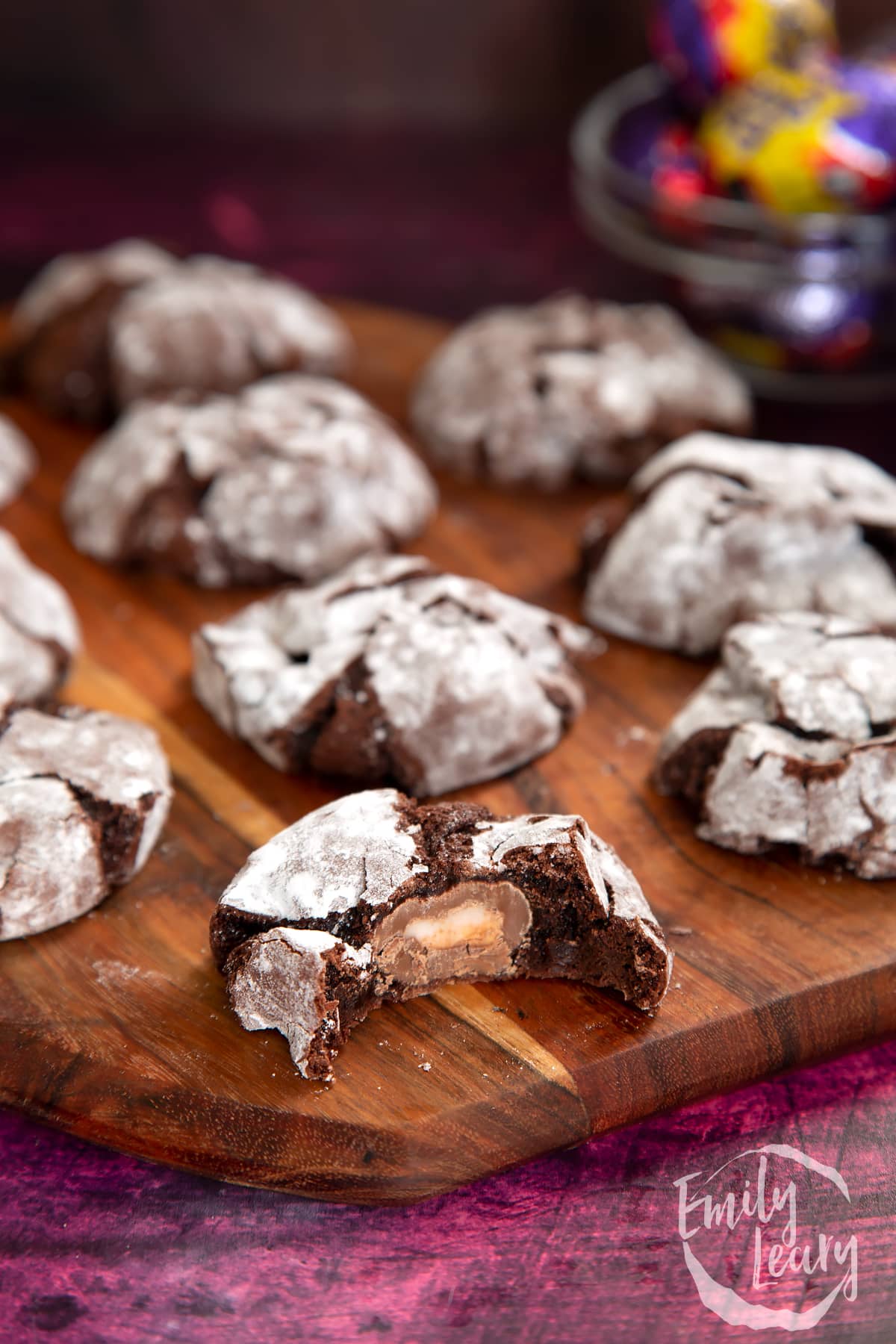 Finished Cadbury Creme Egg cookies on a wooden board. 