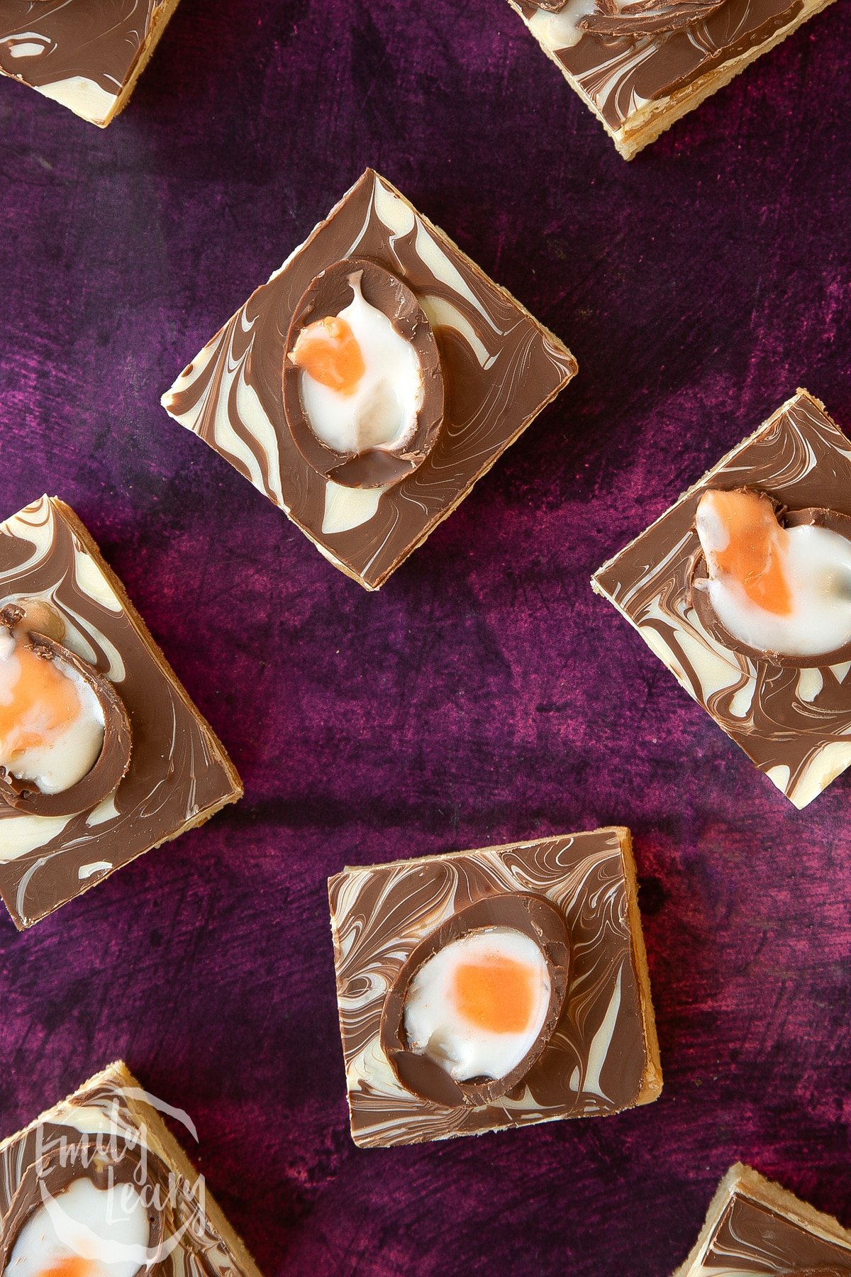Easter millionaires shortbread slices on a purple background.