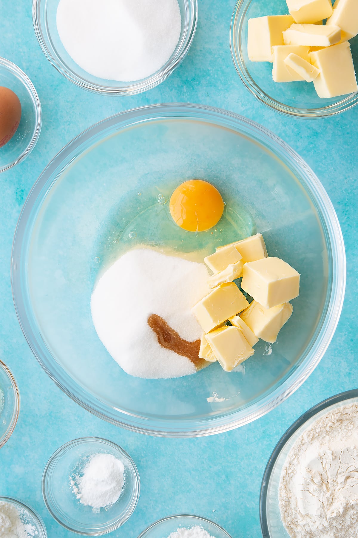 Overhead shot of butter, eggs, sugar and vanilla in a mixing bowl.