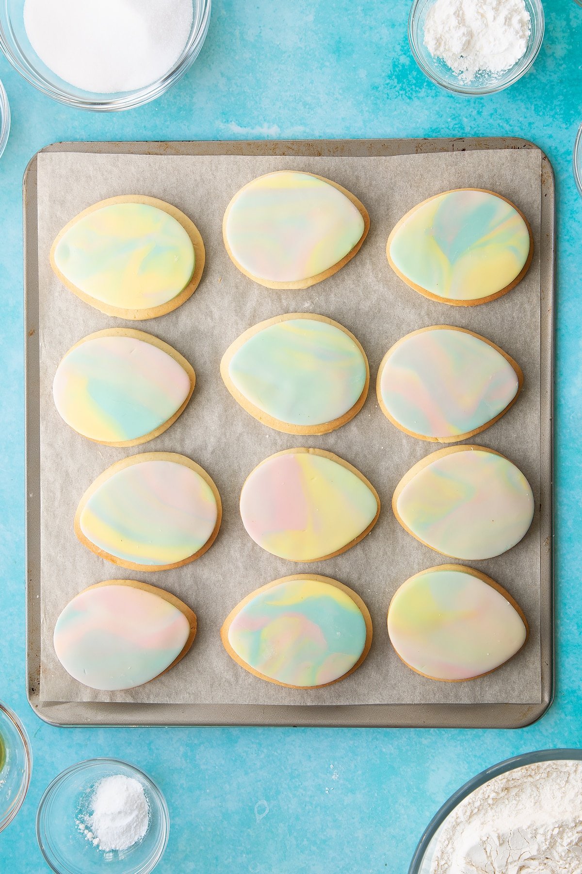 Adding the finished sugar pieces to the top of the cookie eggs.