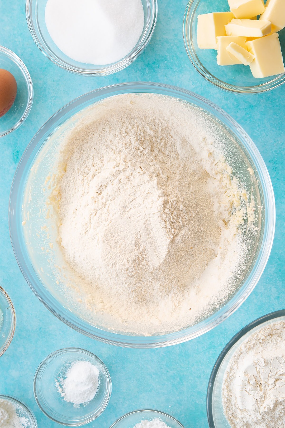 Sifting the flour and bicarb into the wet mixture in a glass bowl.