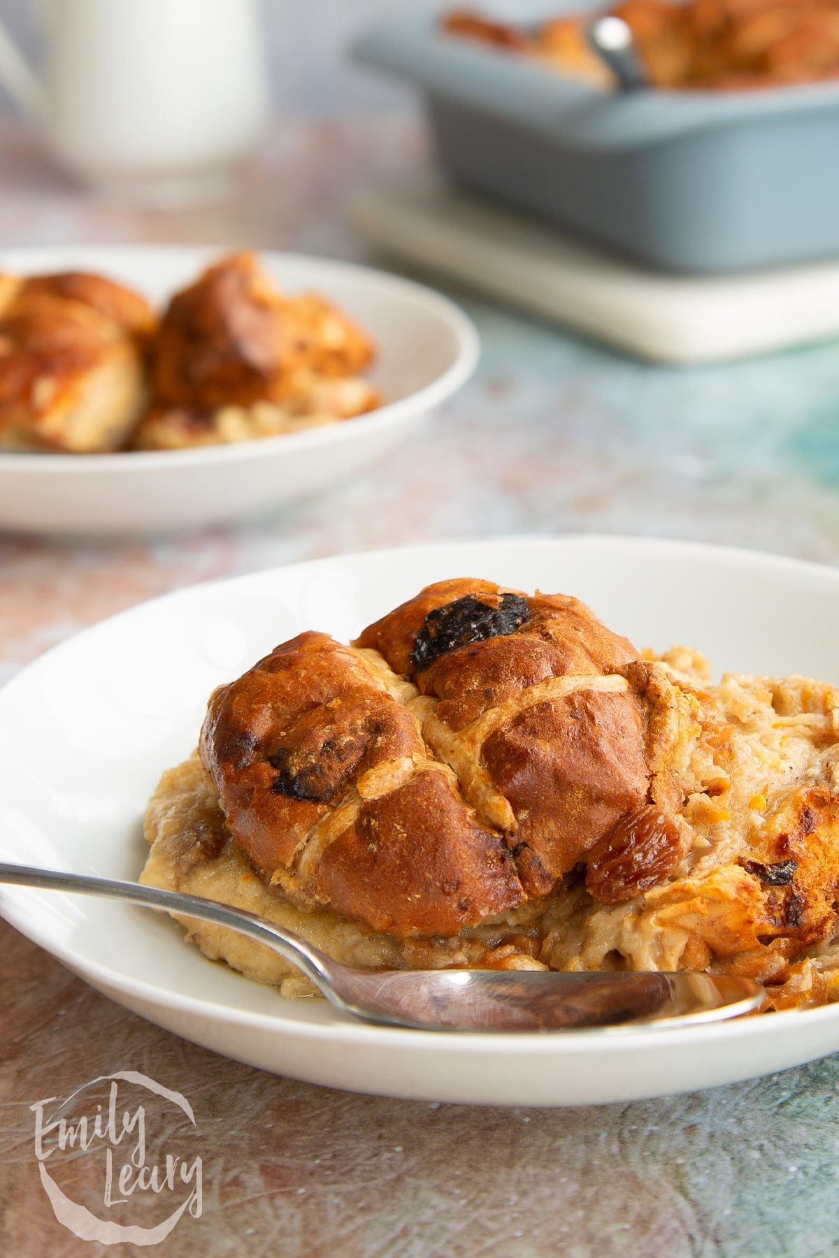 Side on shot of a bowl of the finished hot cross bun bread and butter pudding.