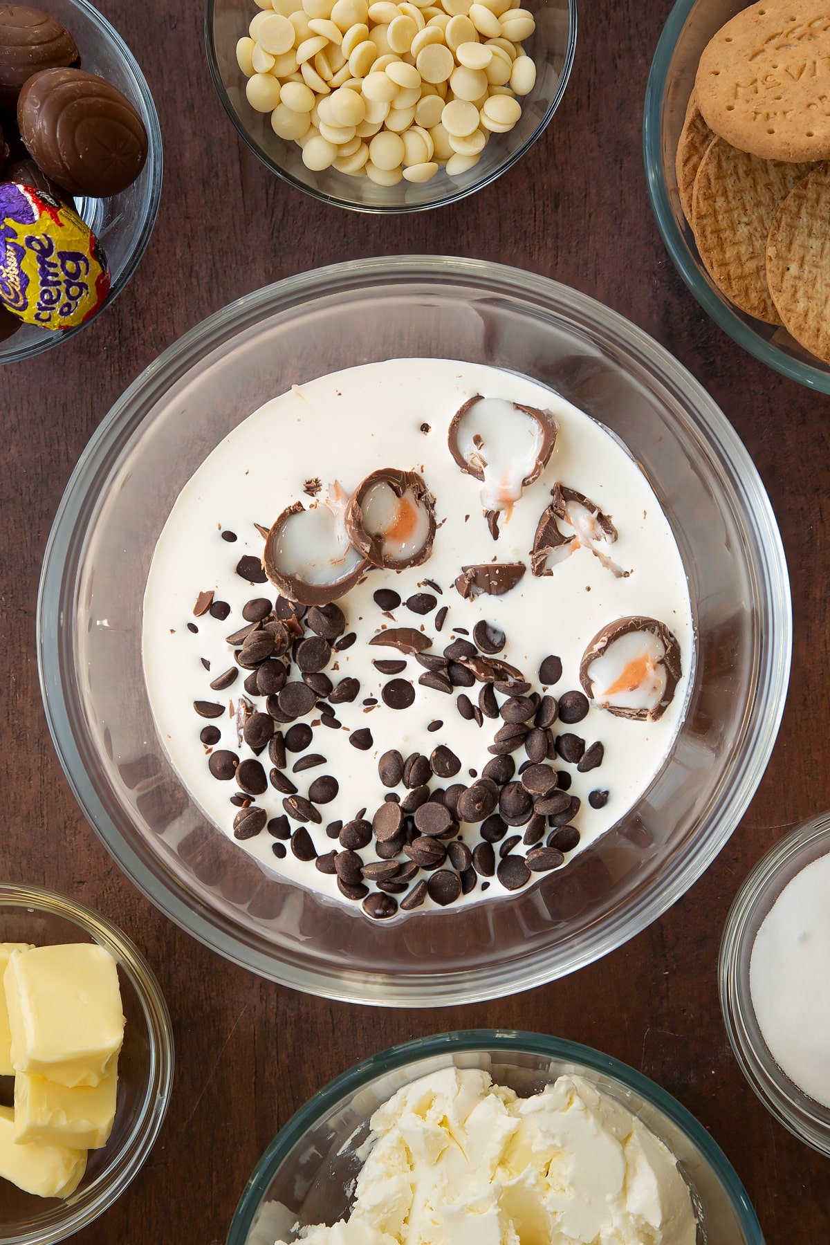 Adding the wet ingredients for the Cadbury Creme Egg cheesecake together into a mixing bowl.