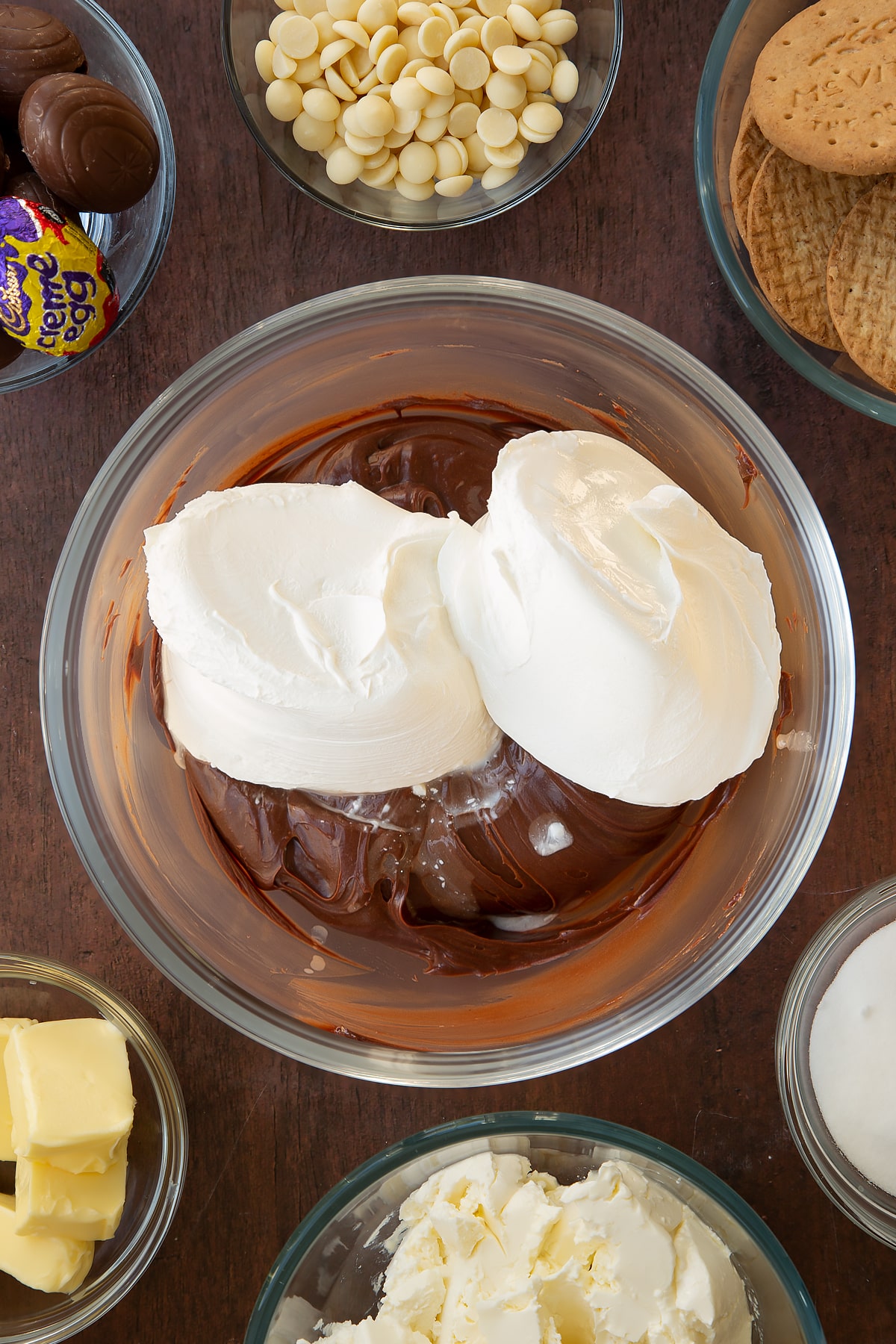 Adding the cream cheese to the bowl of cooled ganache. 