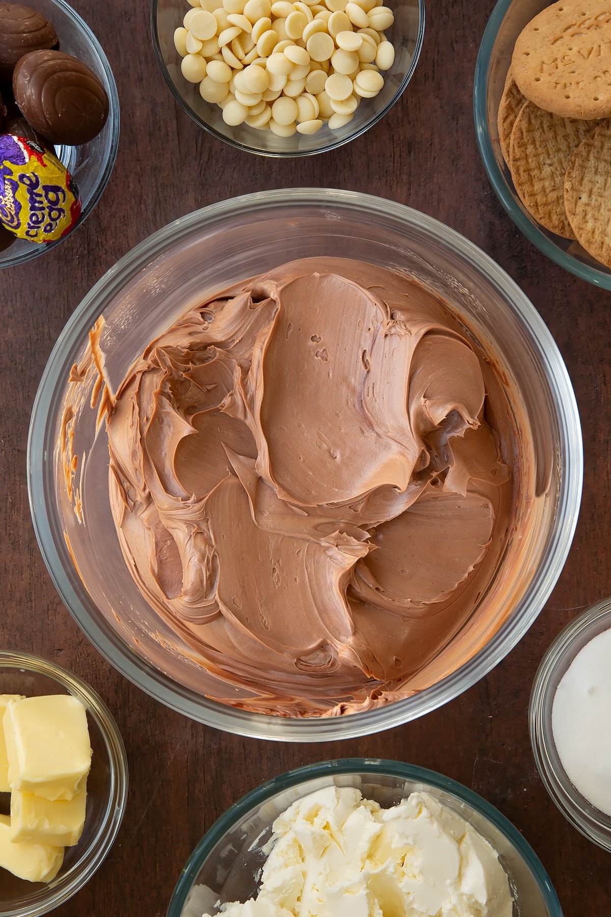 Overhead shot of the mixing bowl after the cream has been mixed into the wet Cadbury Creme Egg cheesecake ingredients. 