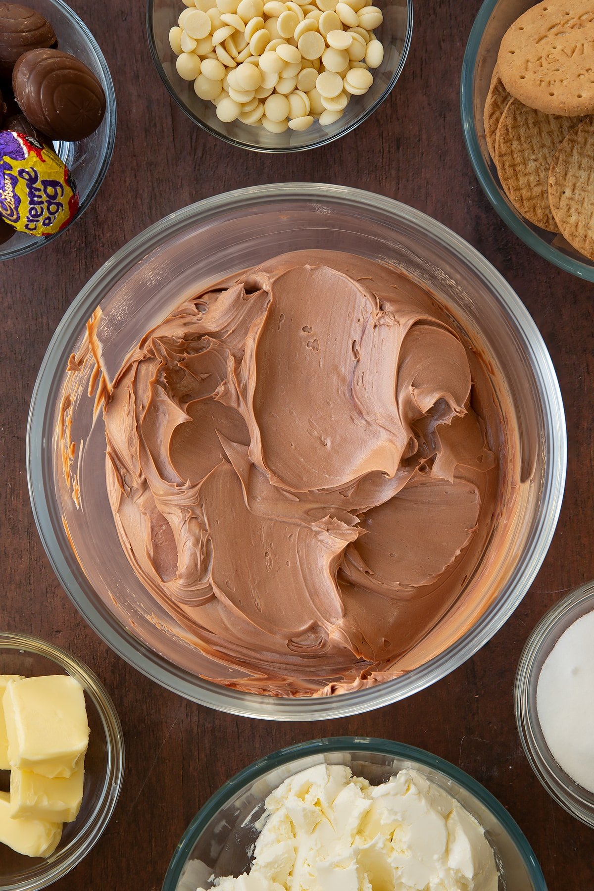 Overhead shot of the mixing bowl after the cream has been mixed into the wet Cadbury Creme Egg cheesecake ingredients. 