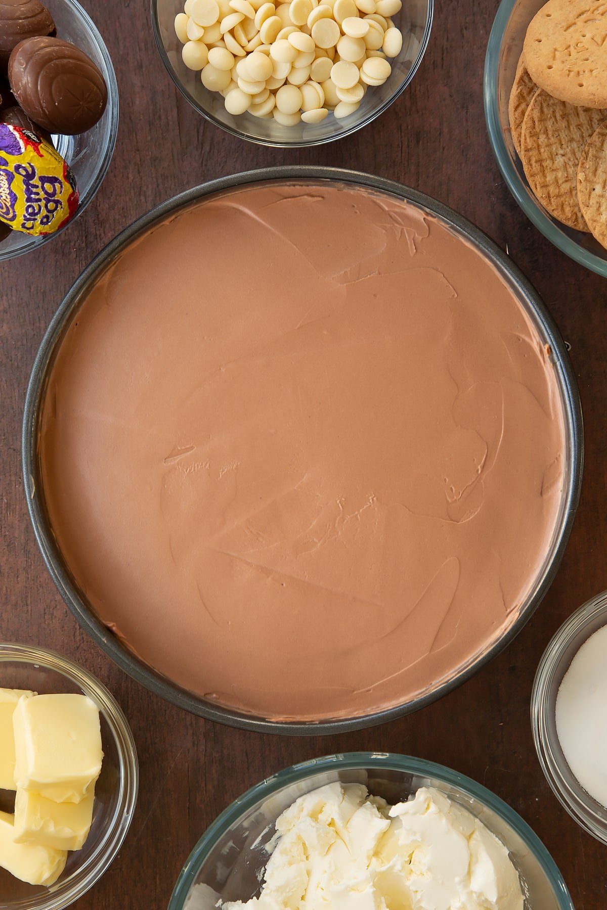 Overhead shot of the Cadbury Creme Egg cheesecake after the filling has been smoothed across the top.