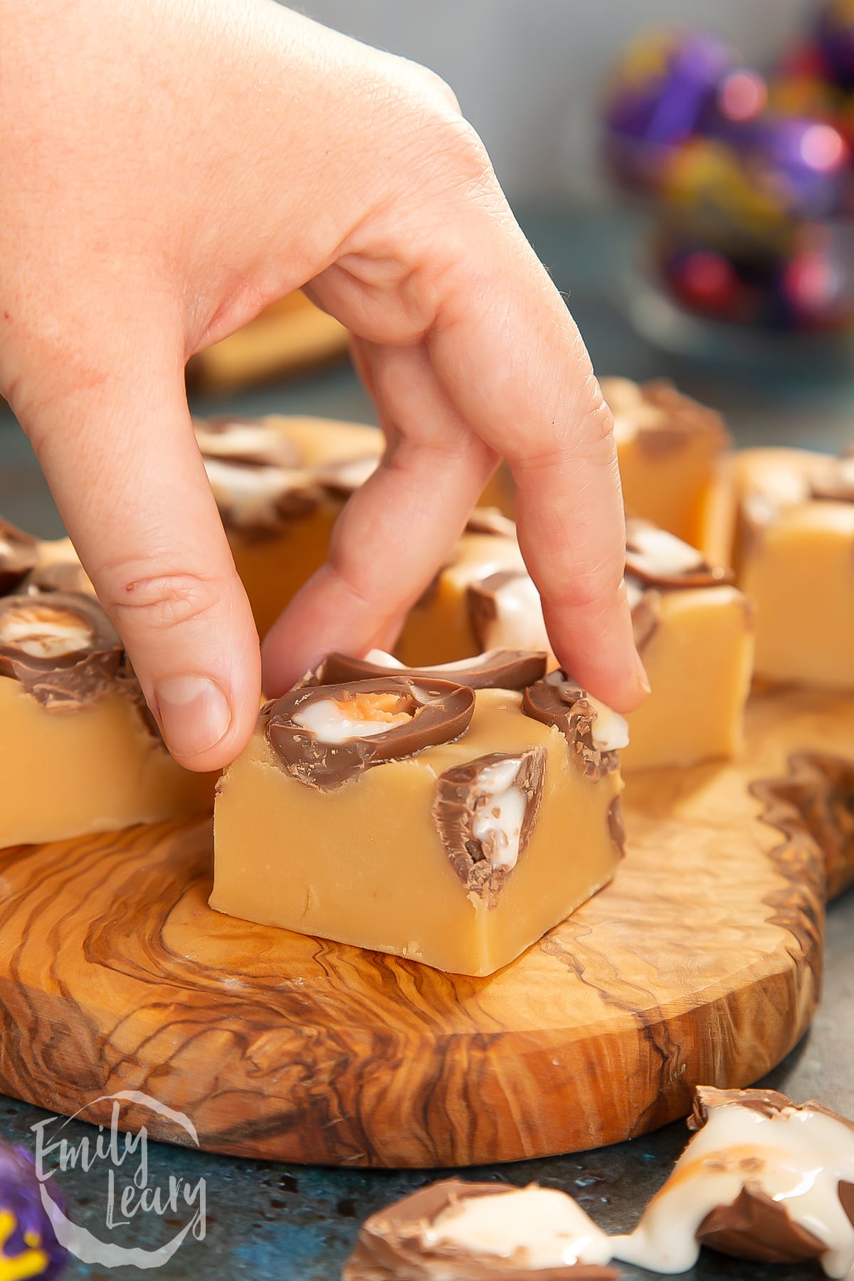 Hand reaching in to grab a piece of the finished Cadbury Creme Egg fudge