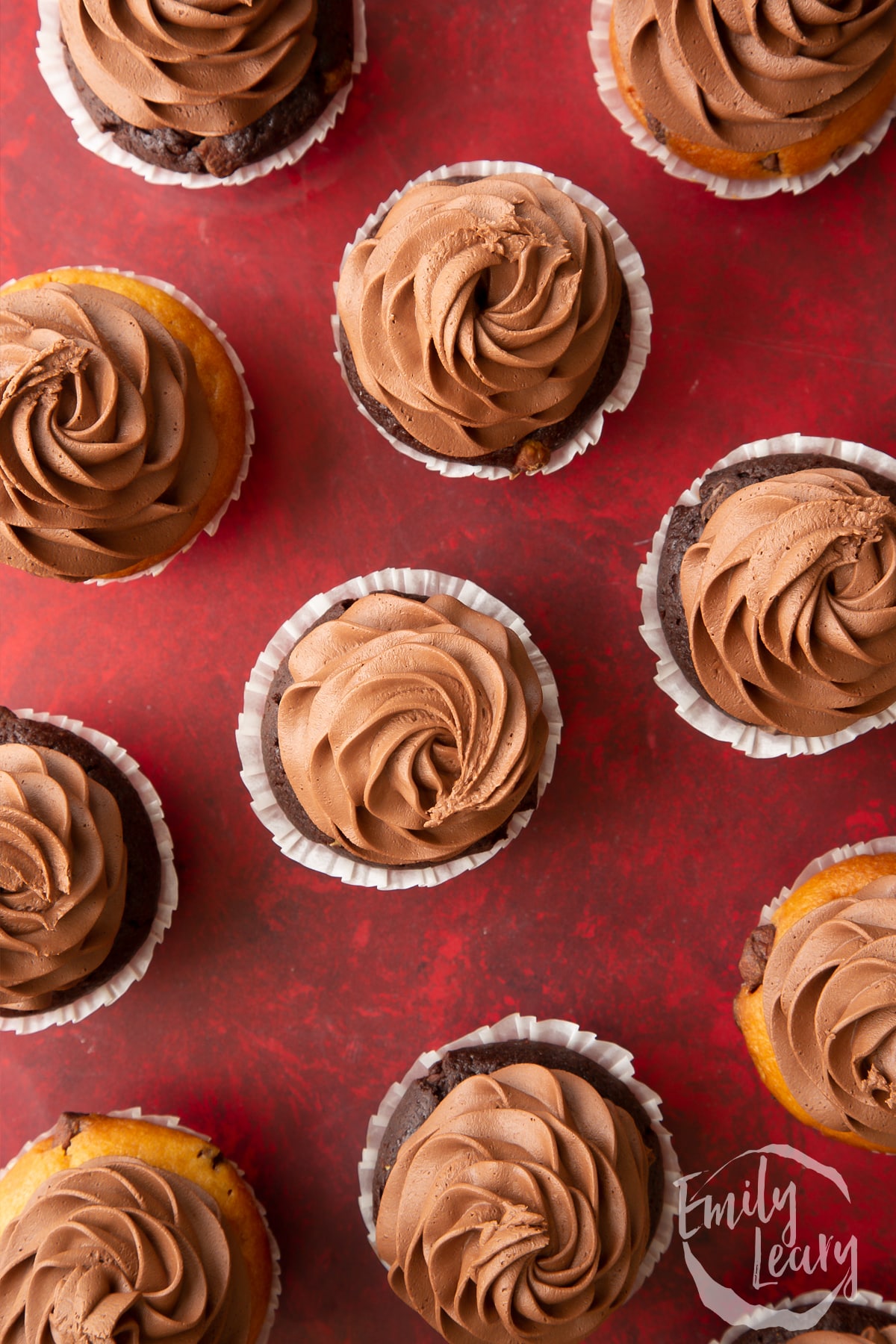 Overhead shot of chocolate muffins with chocolate buttercream icing.