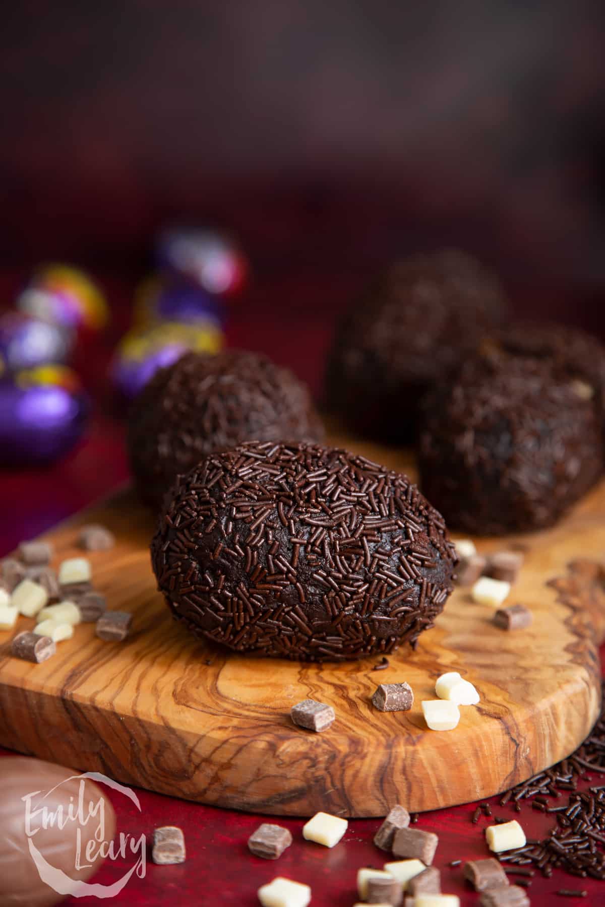 Finished creme Egg Scotch egg on a wooden board.