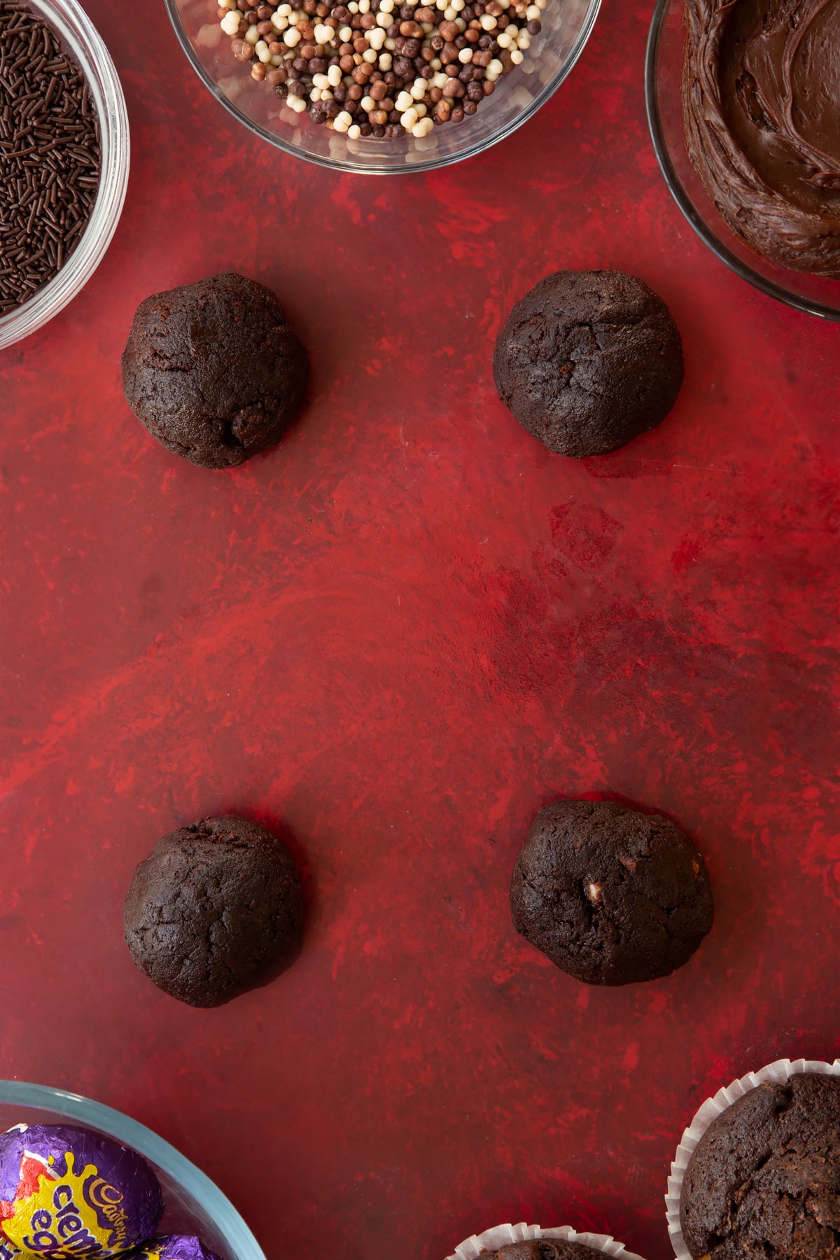 Four balls of the muffin dough for the creme Egg Scotch eggs.