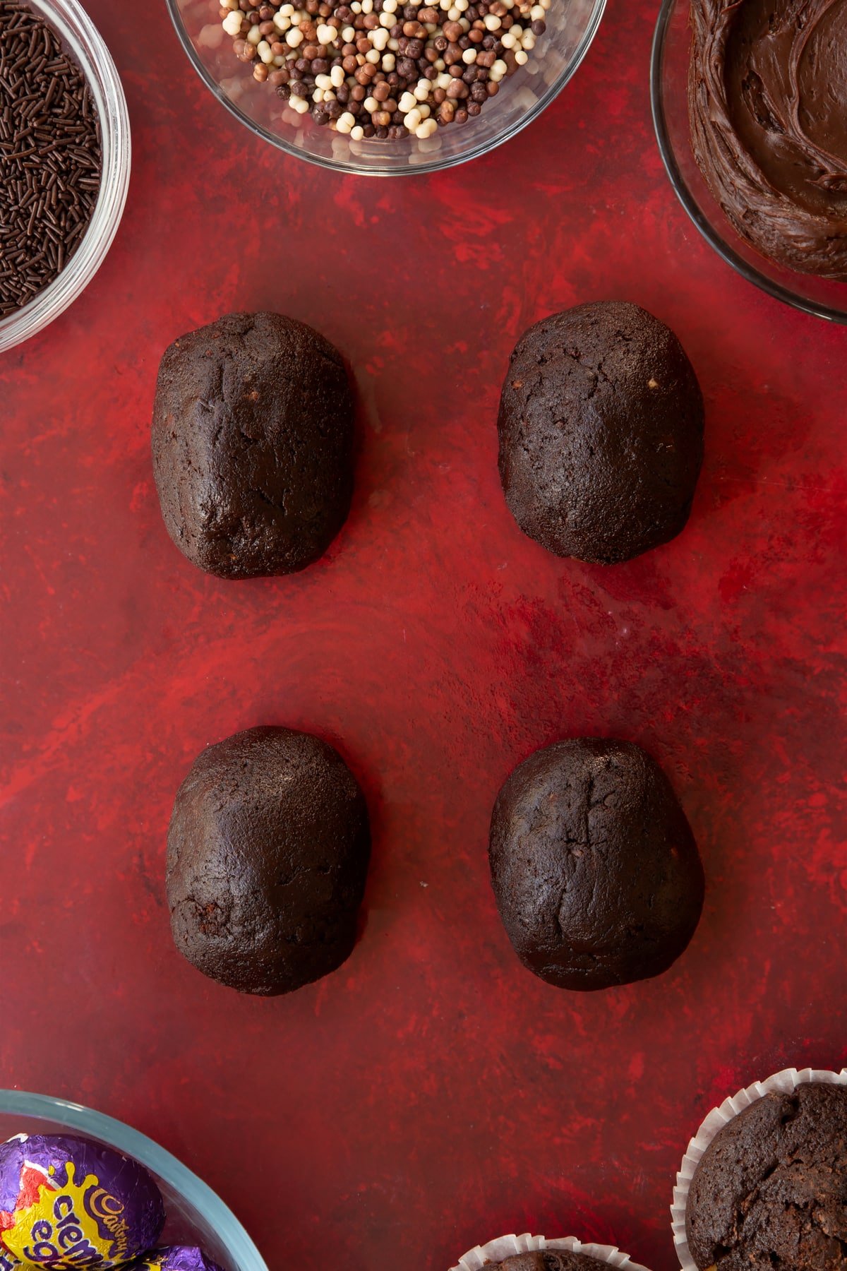 Rolling the dough up and around the creme egg. 