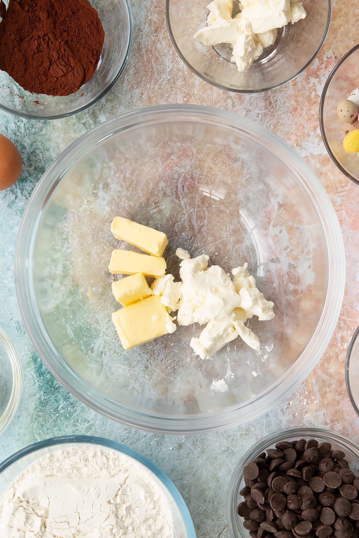 Overhead shot of butter and cream cheese in a bowl.