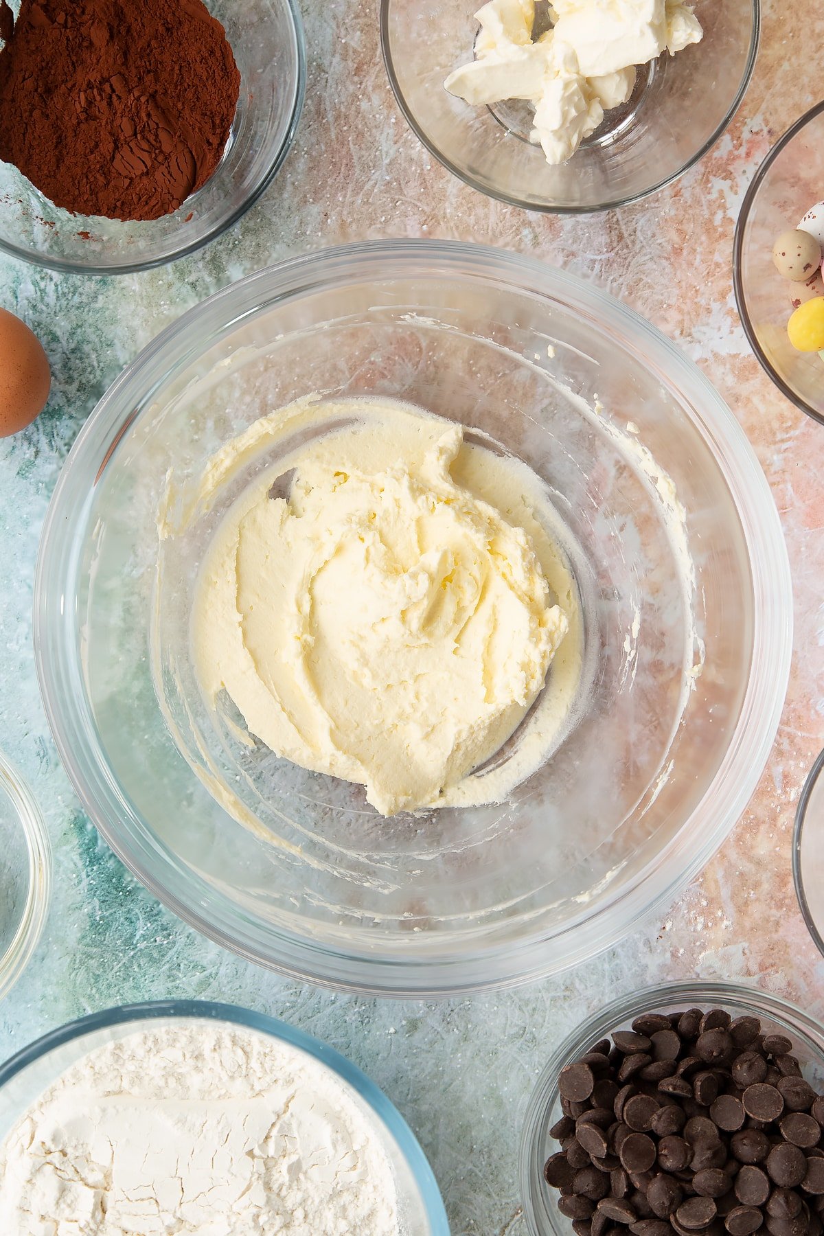 Overhead shot of the butter and cream cheese after the two have been mixed together in a mixing bowl.