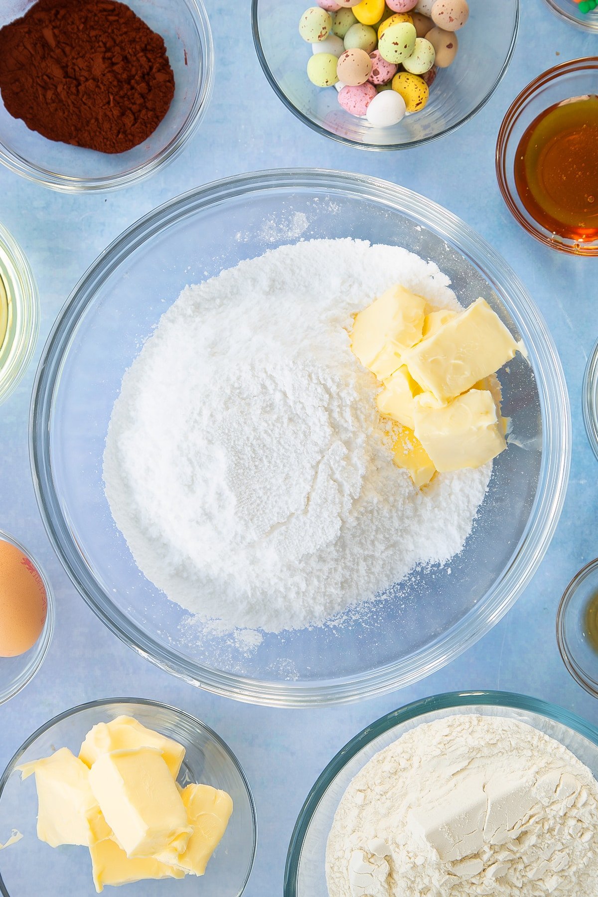 Icing sugar, butter, milk and vanilla in a mixing bowl.