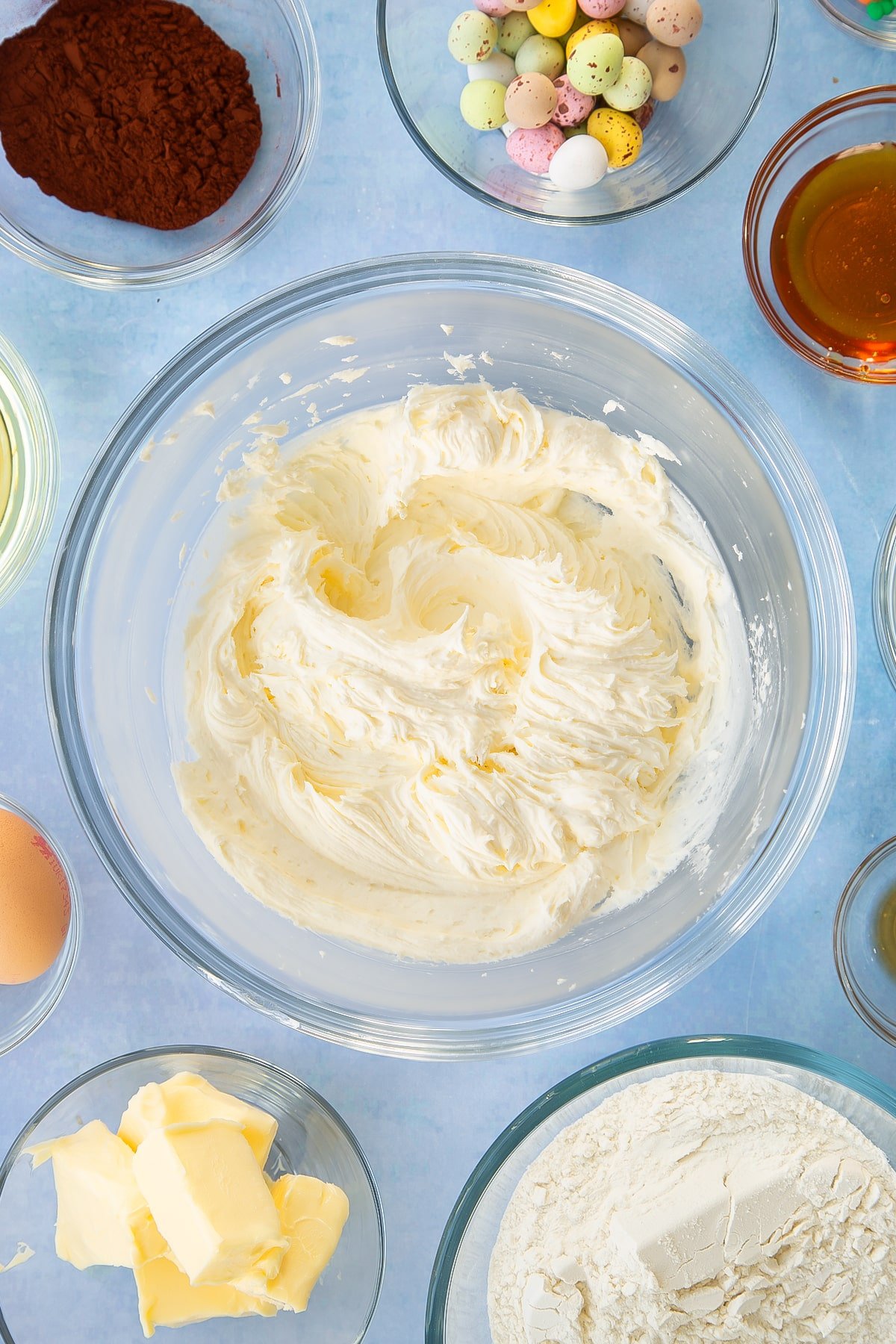 Whisking the icing ingredients in a mixing bowl.