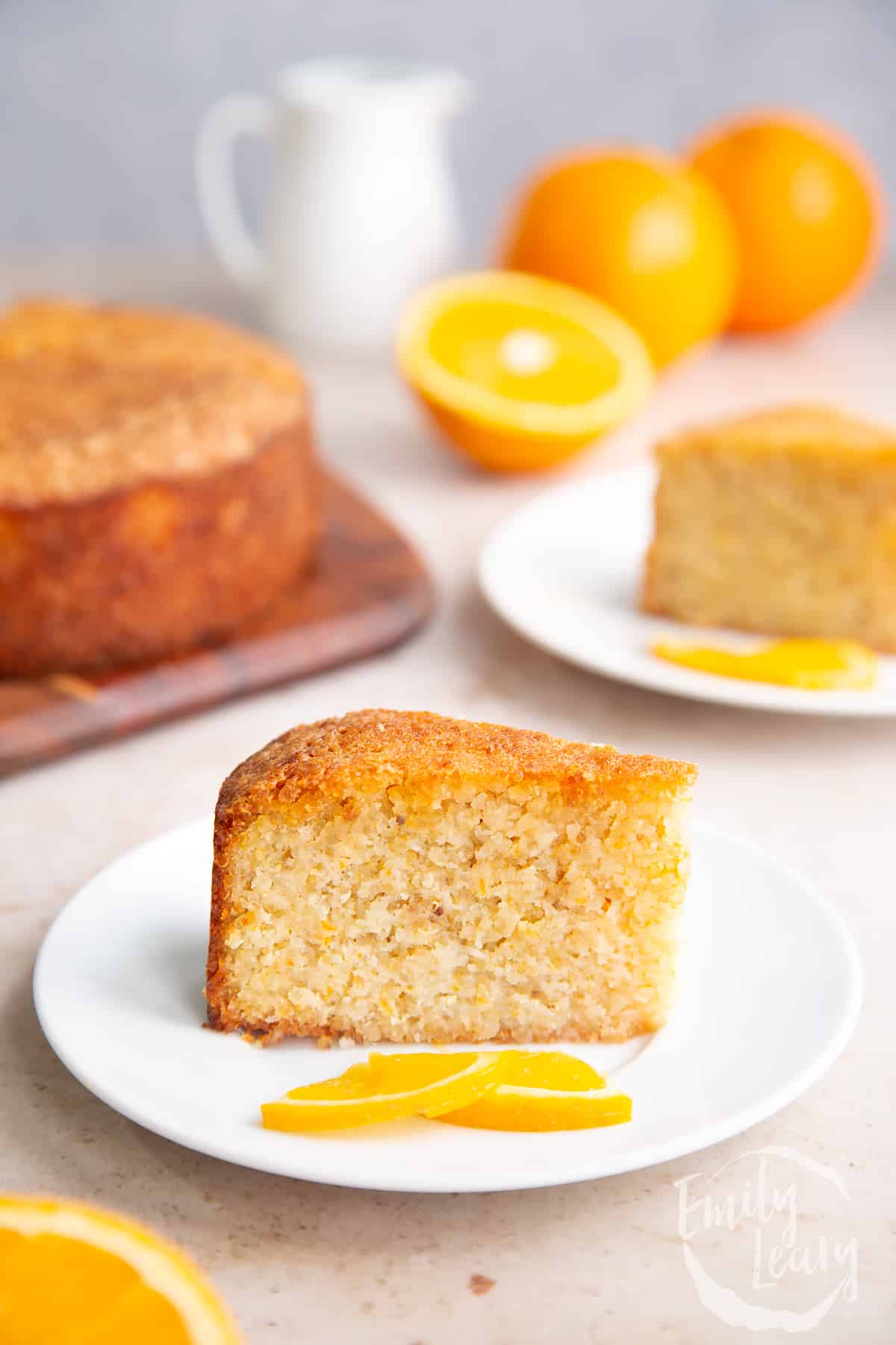 Finished slice of gluten free orange cake on a white plate.