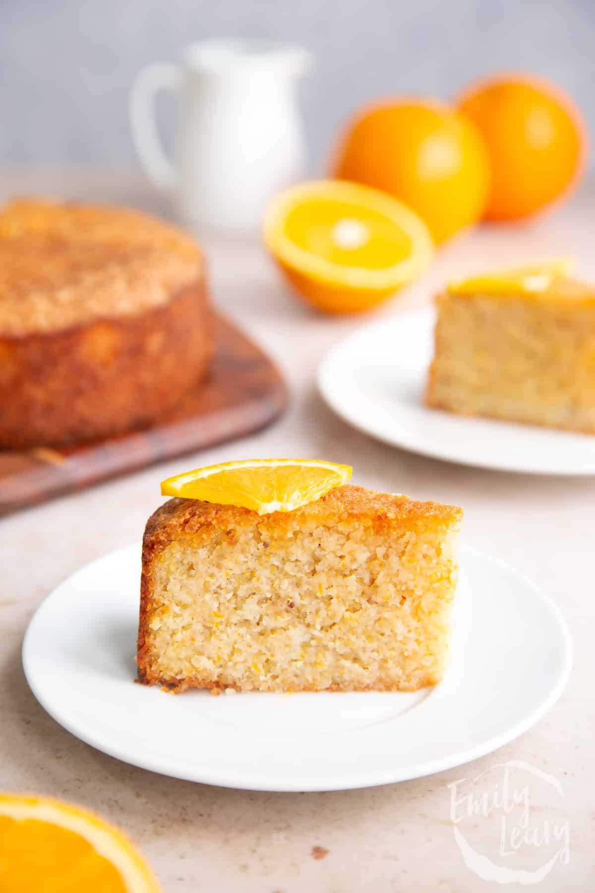 Fisihed slice of gluten free orange cake topped with a small slice of orange. 