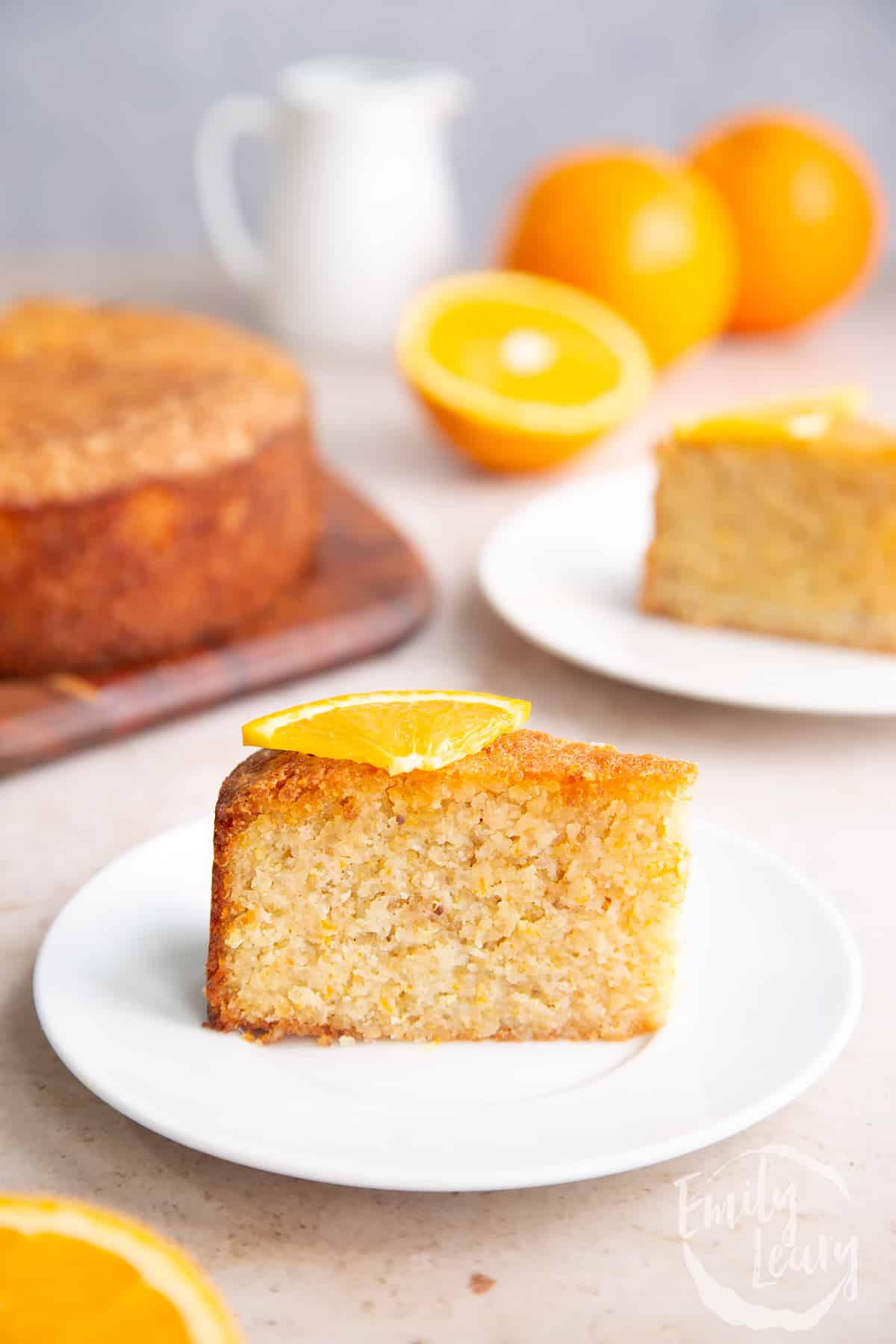 Fisihed slice of gluten free orange cake topped with a small slice of orange.