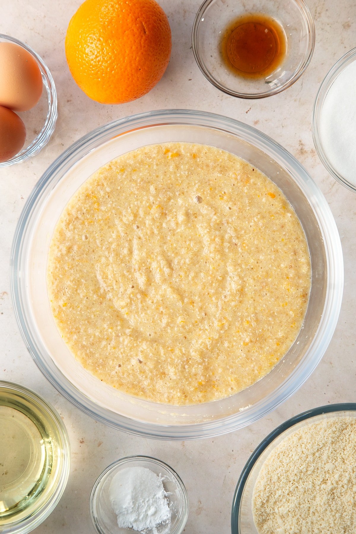 Overhead shot of the ingredients having been whisked together in a large clear bowl.