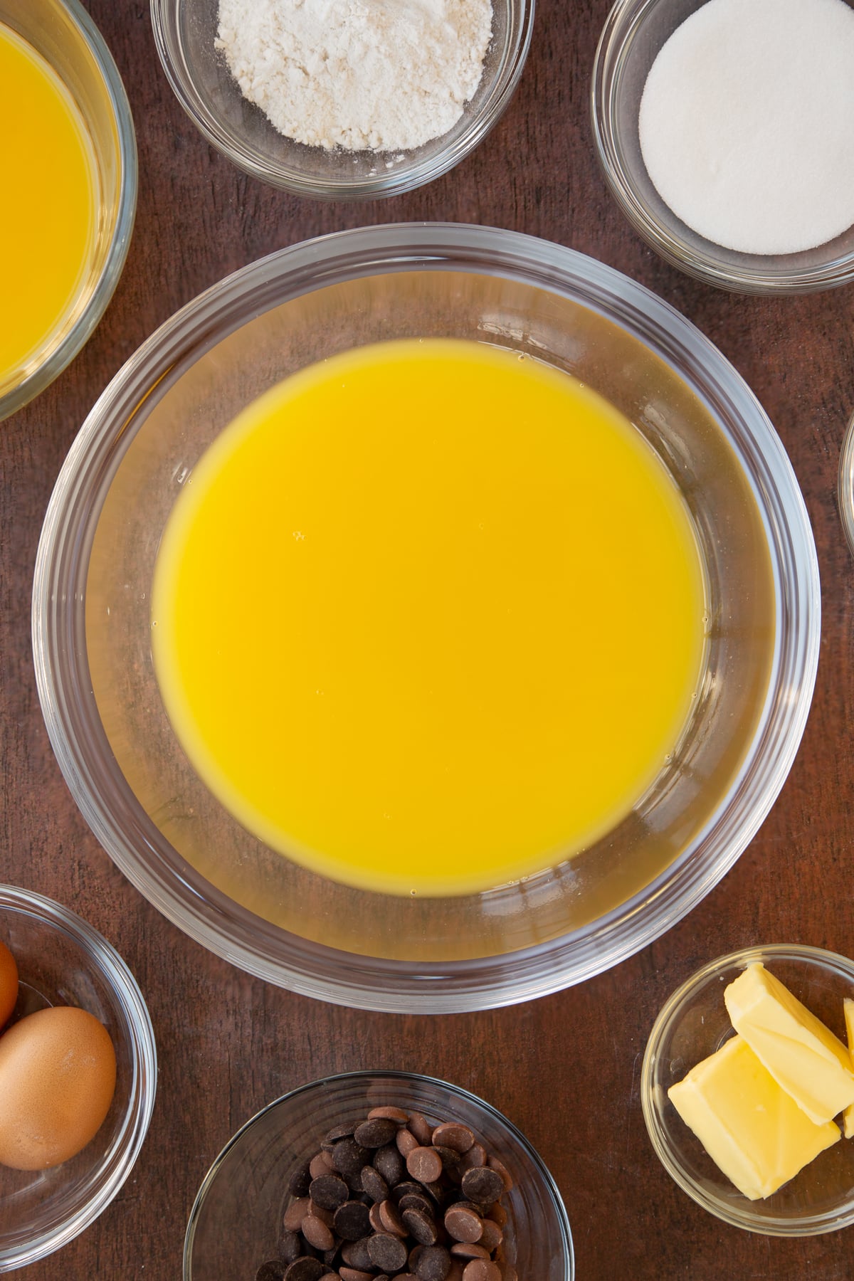 Adding orange juice and the geletine mixture to a mixing bowl.