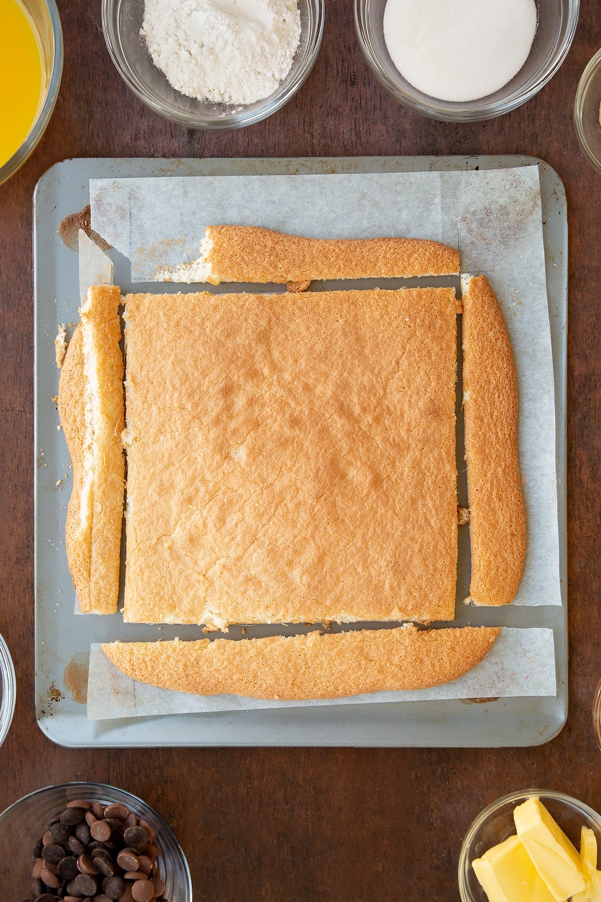 Sponge mixture cut to the lines on the baking sheet.