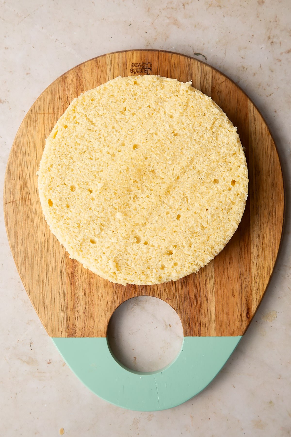 plain sponge cake on a wooden chopping board.