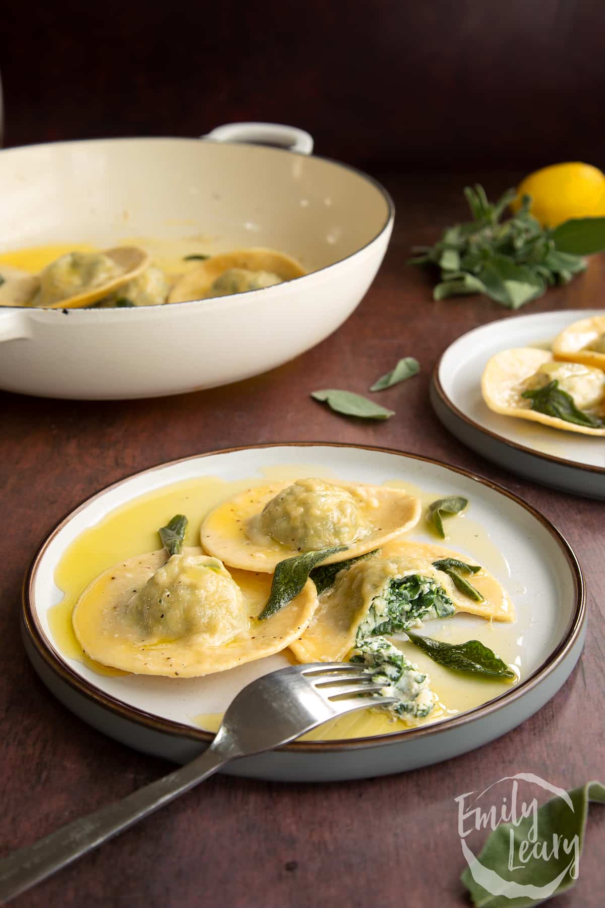 Finished serving of the spinach and ricotta ravioli on a decorative plate.