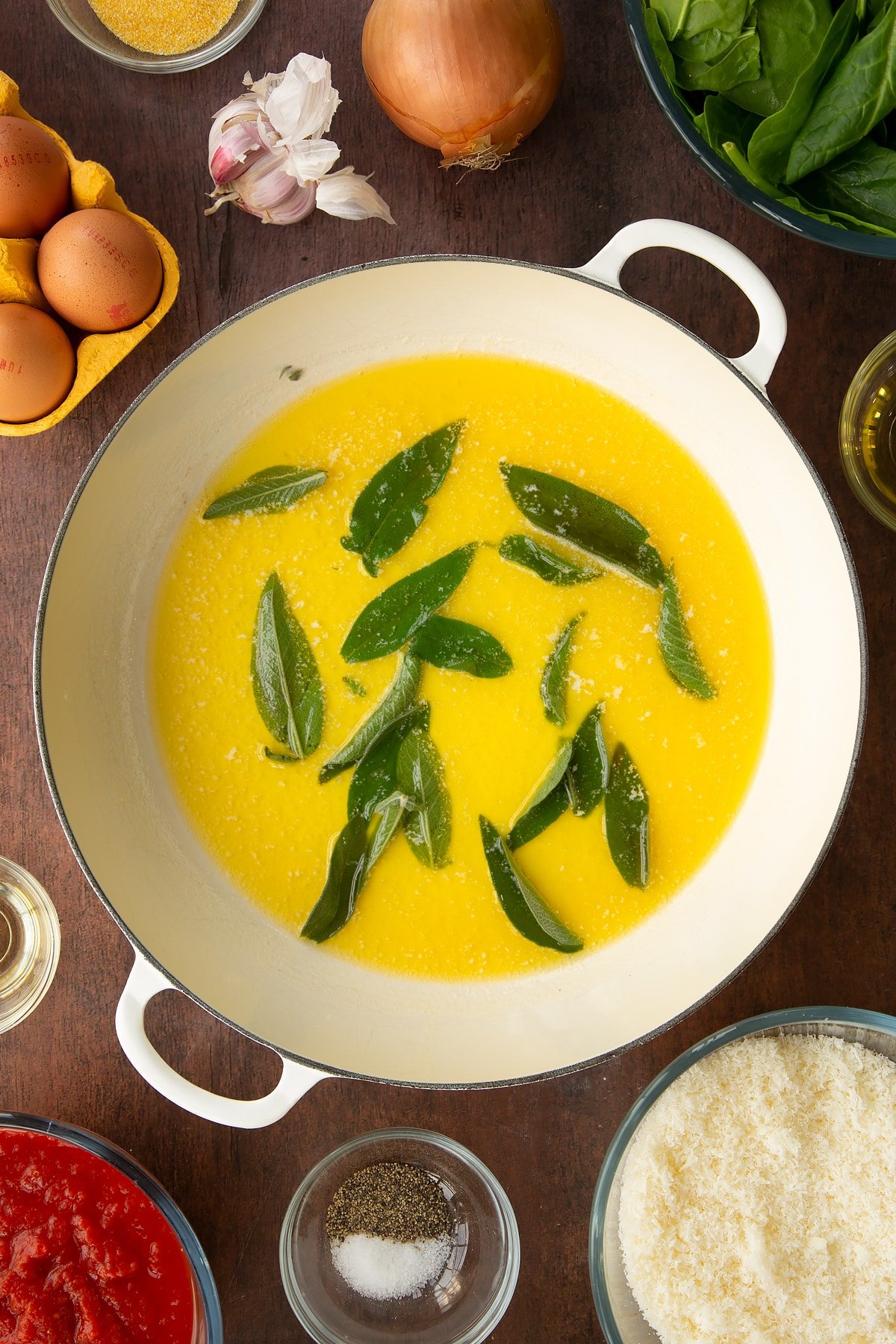 Adding sage to the pan of melted butter.