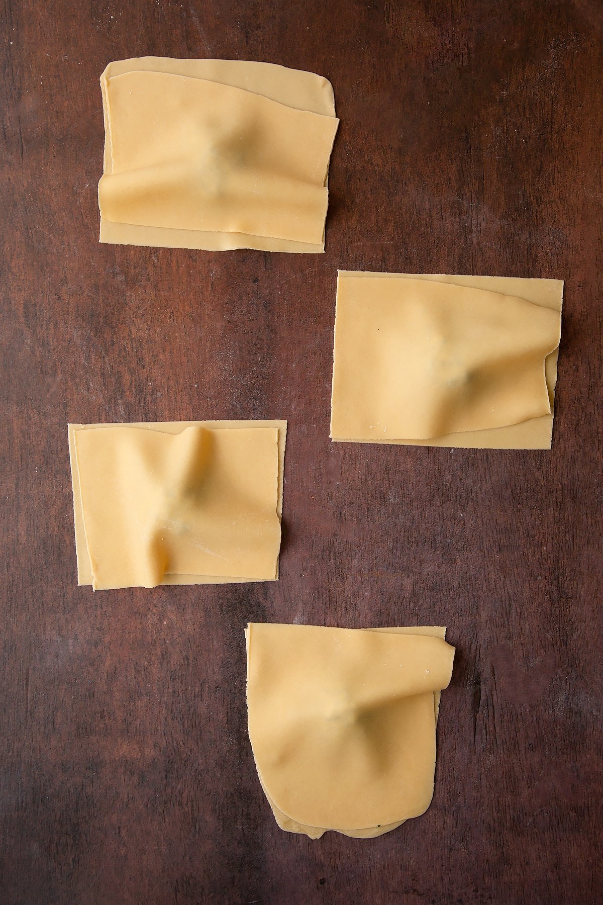 Folding the pasta sheet onto the ricotta mixture.