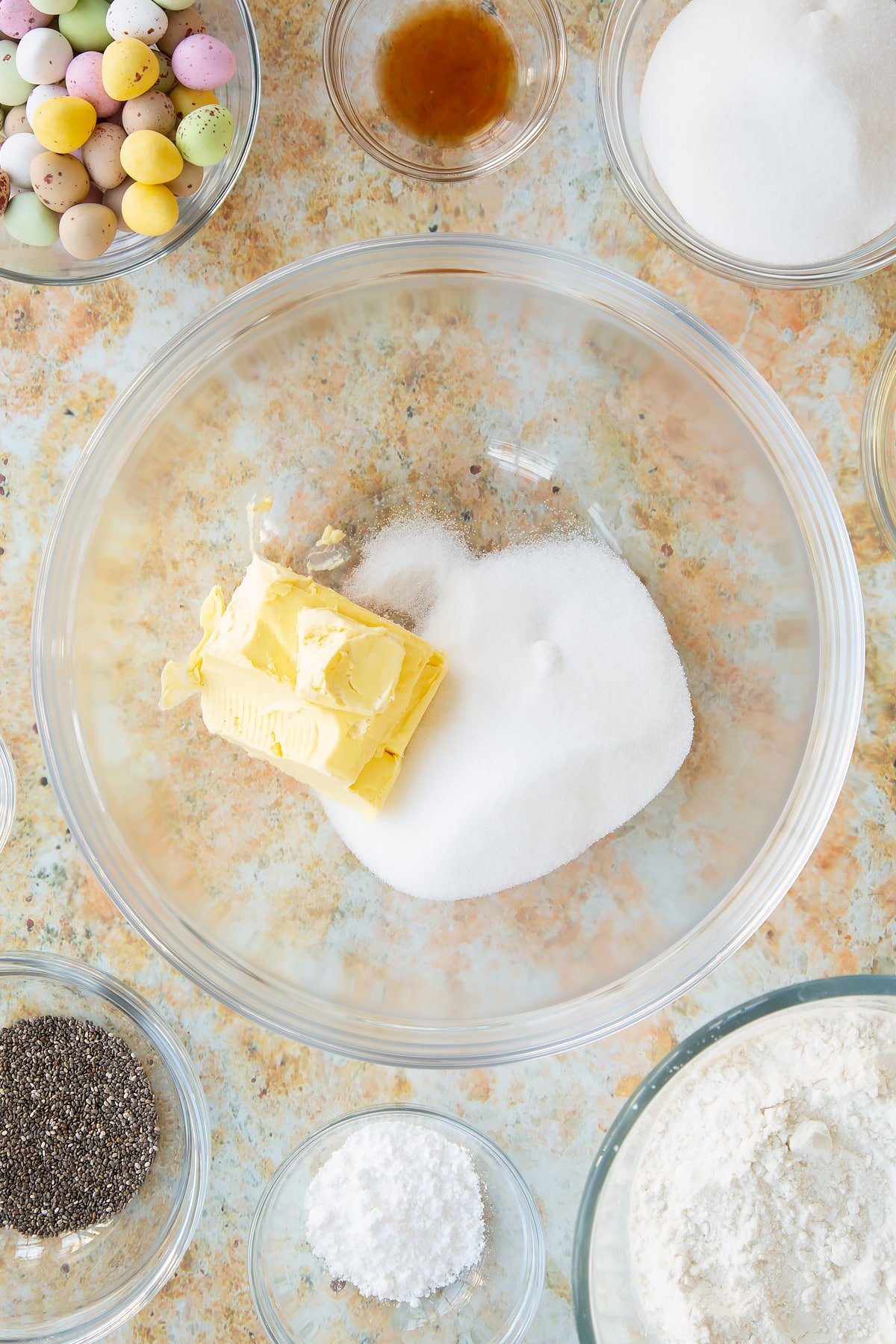 Overhead shot of butter and sugar in a mixing bowl.