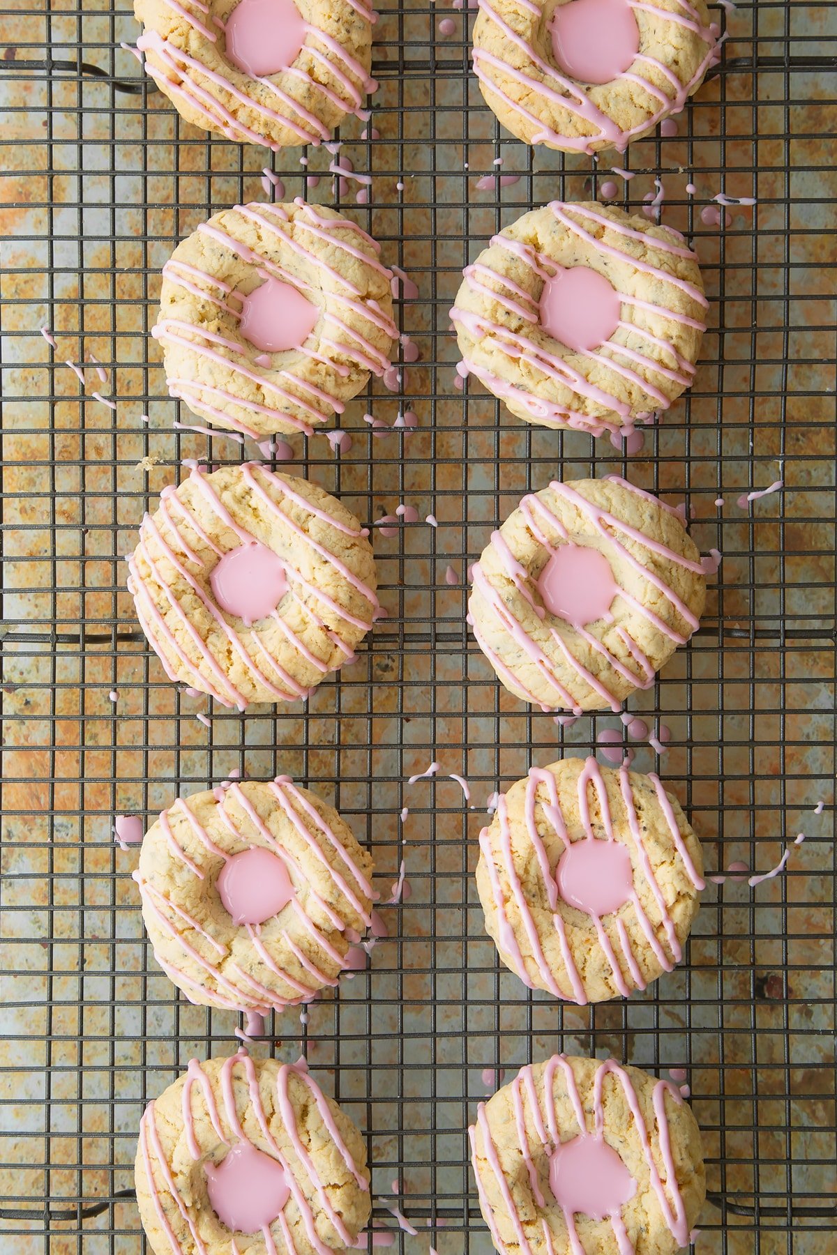 Overhead shot of the pink icing sugar having been squeezed into the centre of the cookies. 