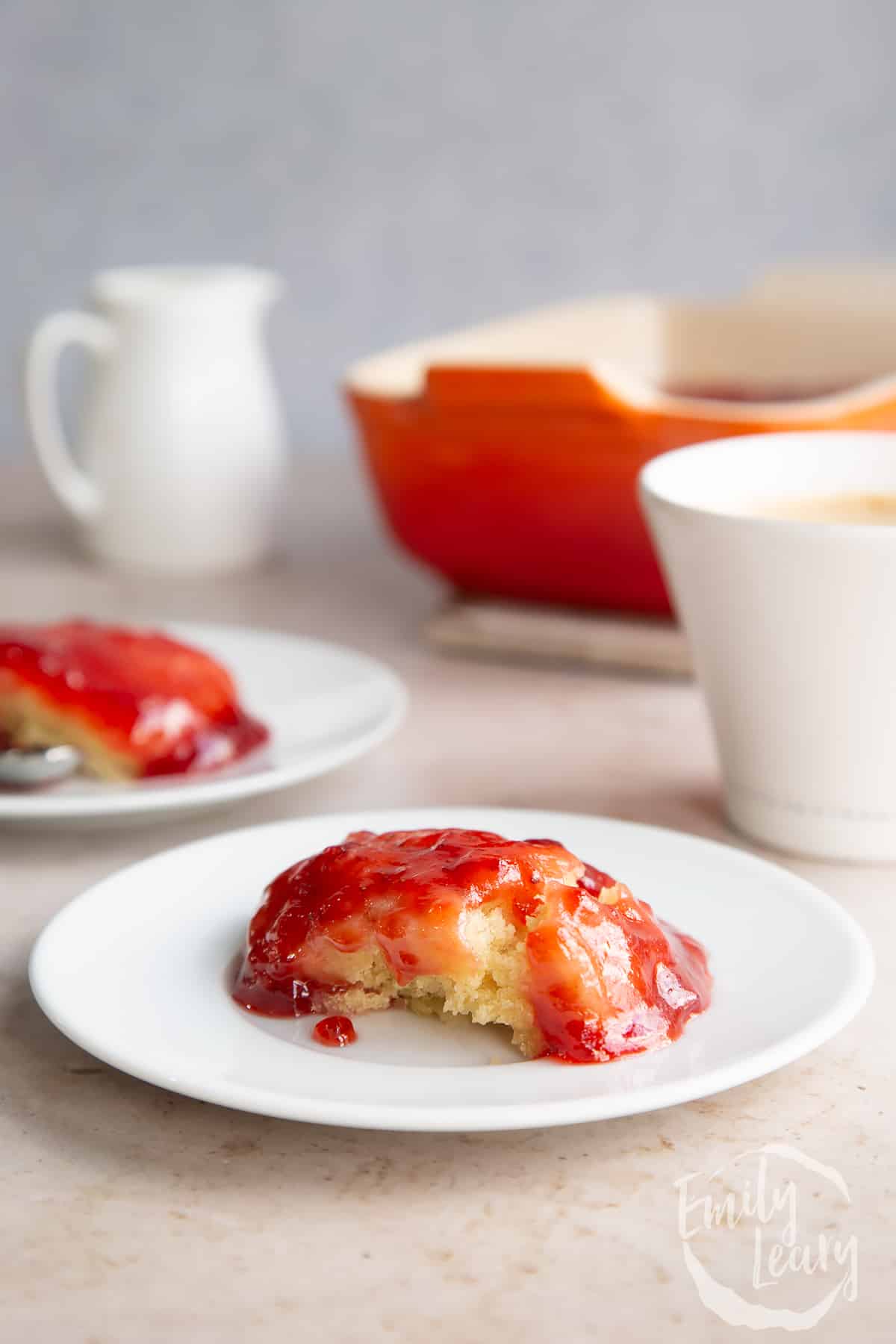 Vegan jam sponge pudding on a white plate.