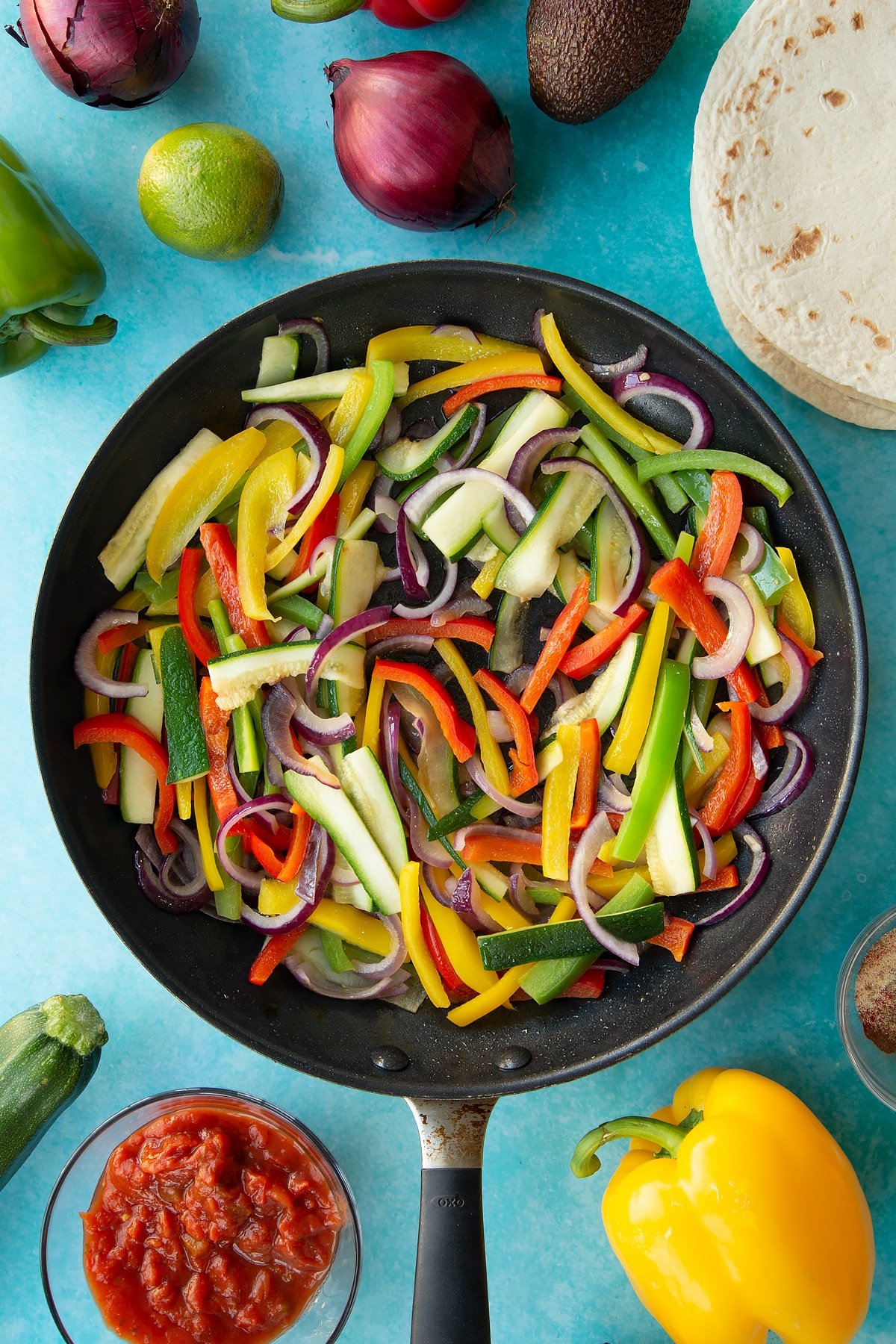 Overhead shot of the lightly fried sliced vegetables in a pan.