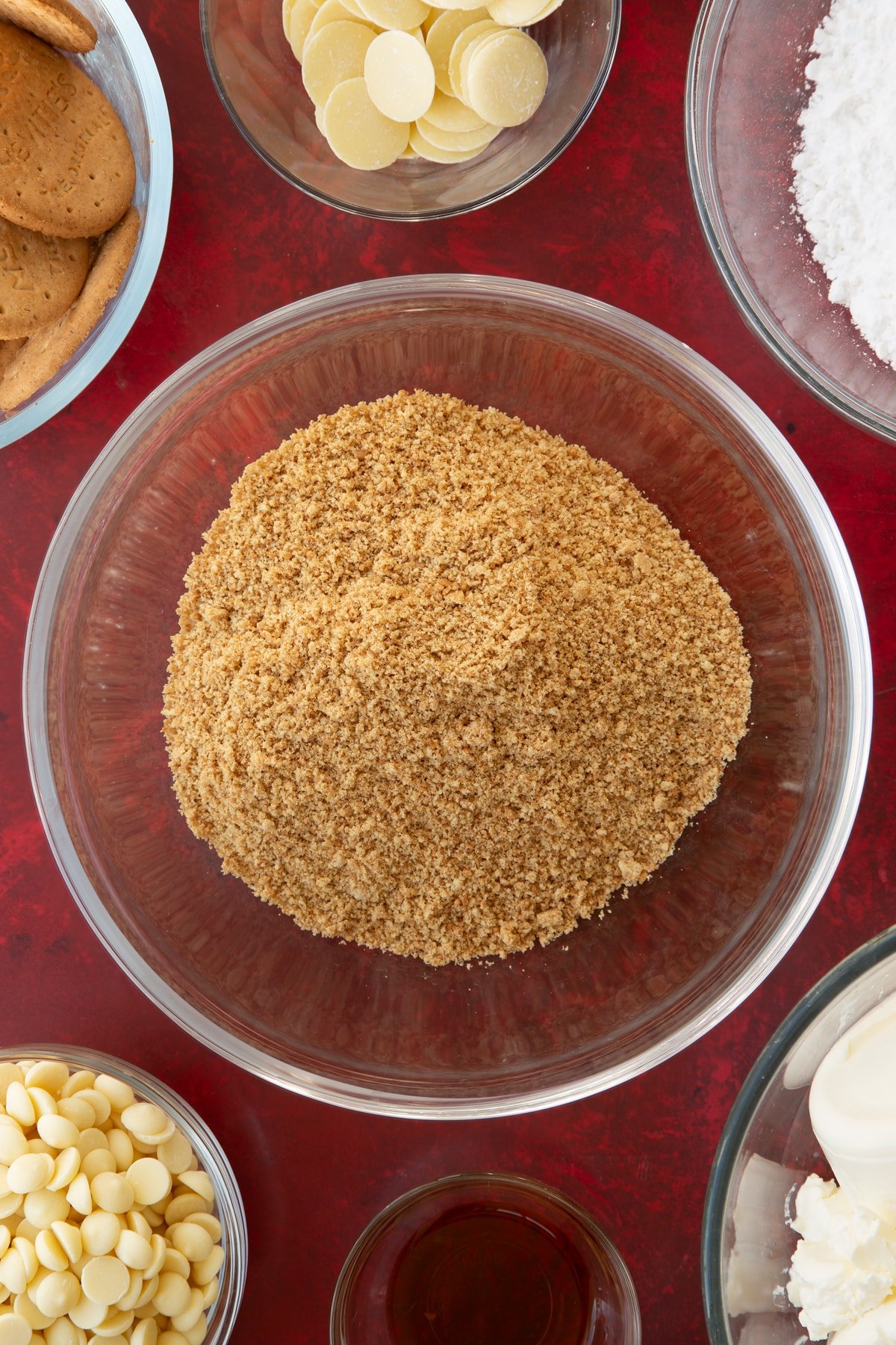 crushed biscuit crumbs in a large clear bowl. 